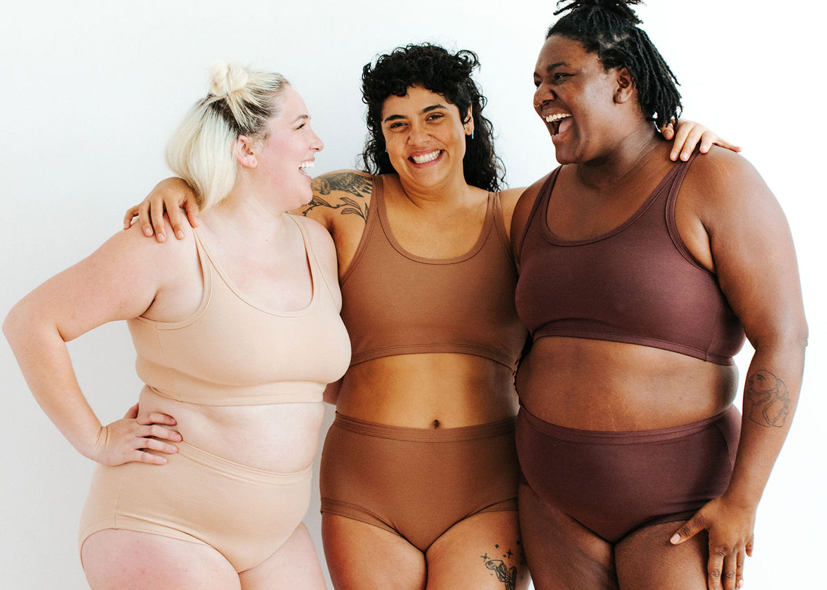 Three models wearing sets of Thunderpants Longline Bras and Original style underwear in our three Neutral colors - Pine Nut, Hazelnut, and Chestnut.