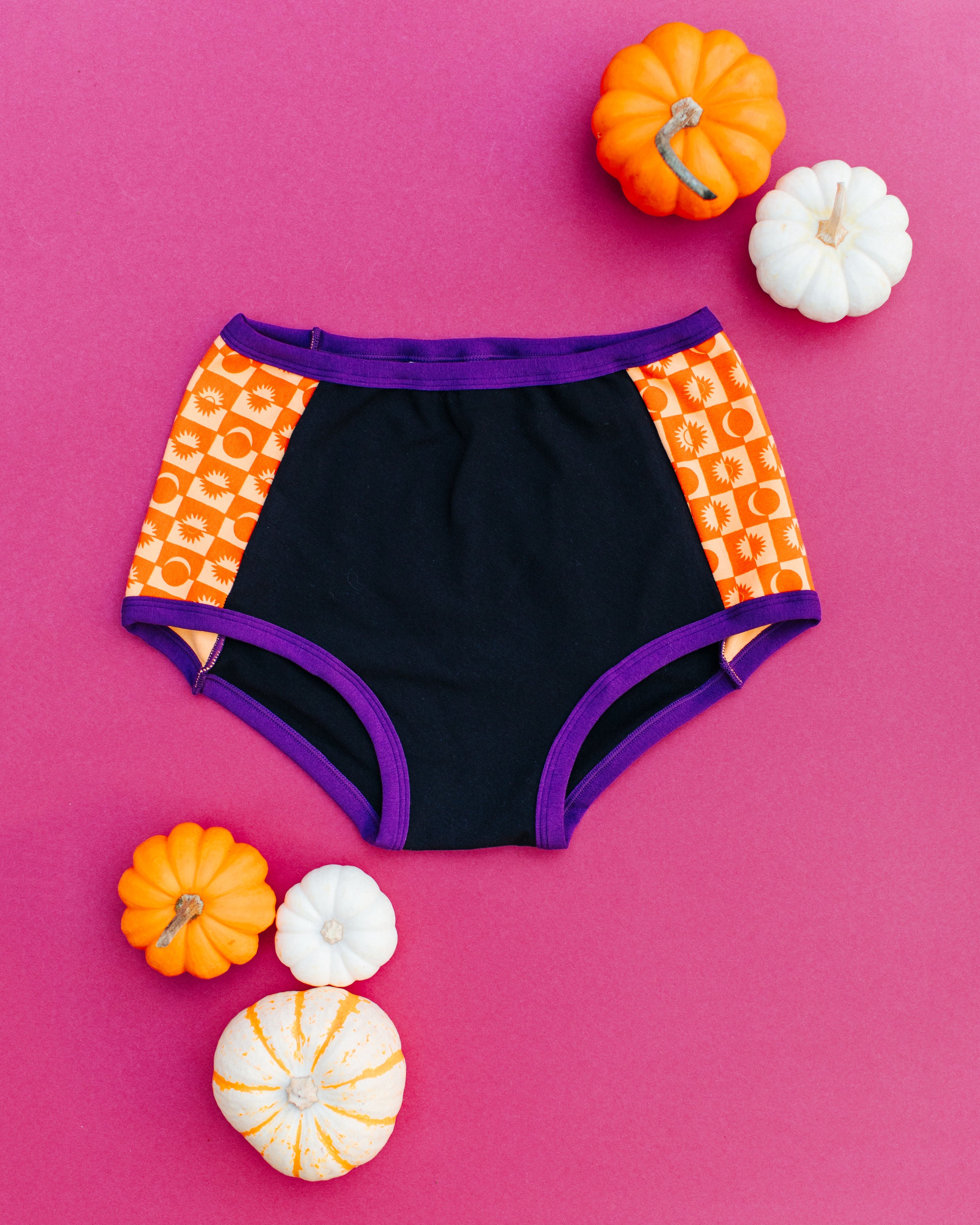 Flat lay of Thunderpants Original Panel Pants style underwear in Witch's Brew: Black with orange Autumn Equinox.