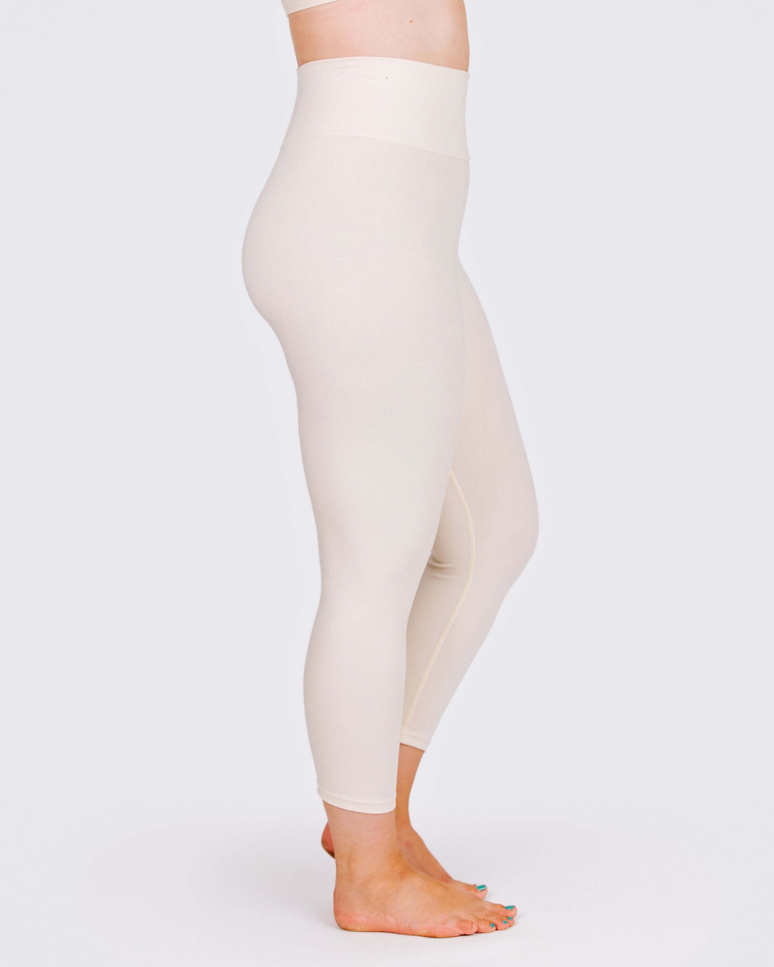 Fit photo from the side of Thunderpants organic cotton 3/4 Length Leggings in off-white on a model.