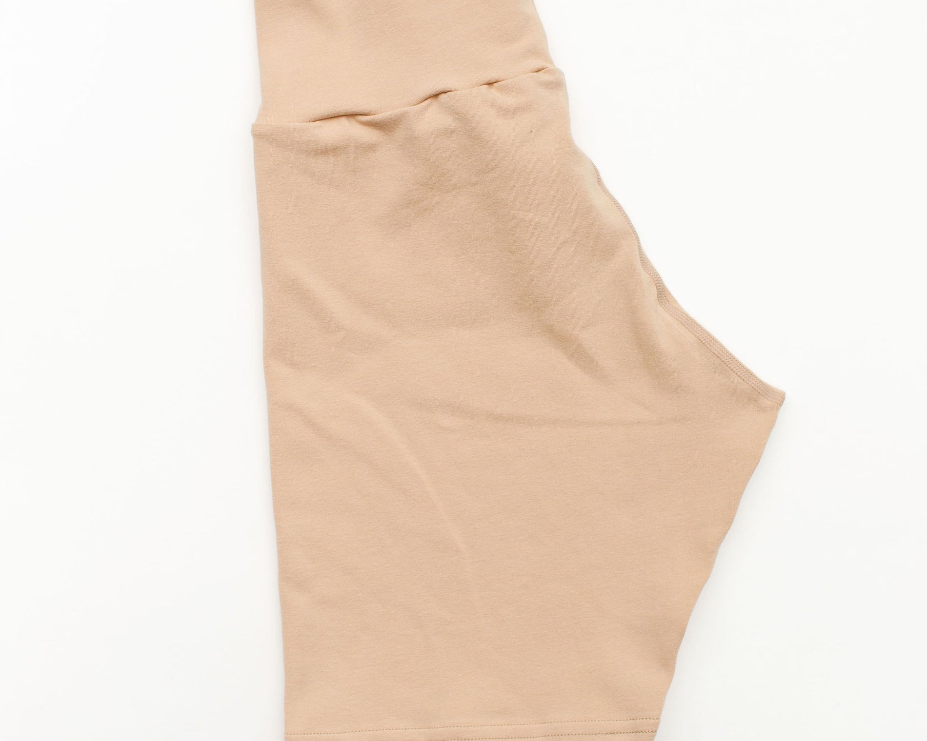 Flat lay of Thunderpants Bike Shorts in Pine Nut color - a lighter tan.