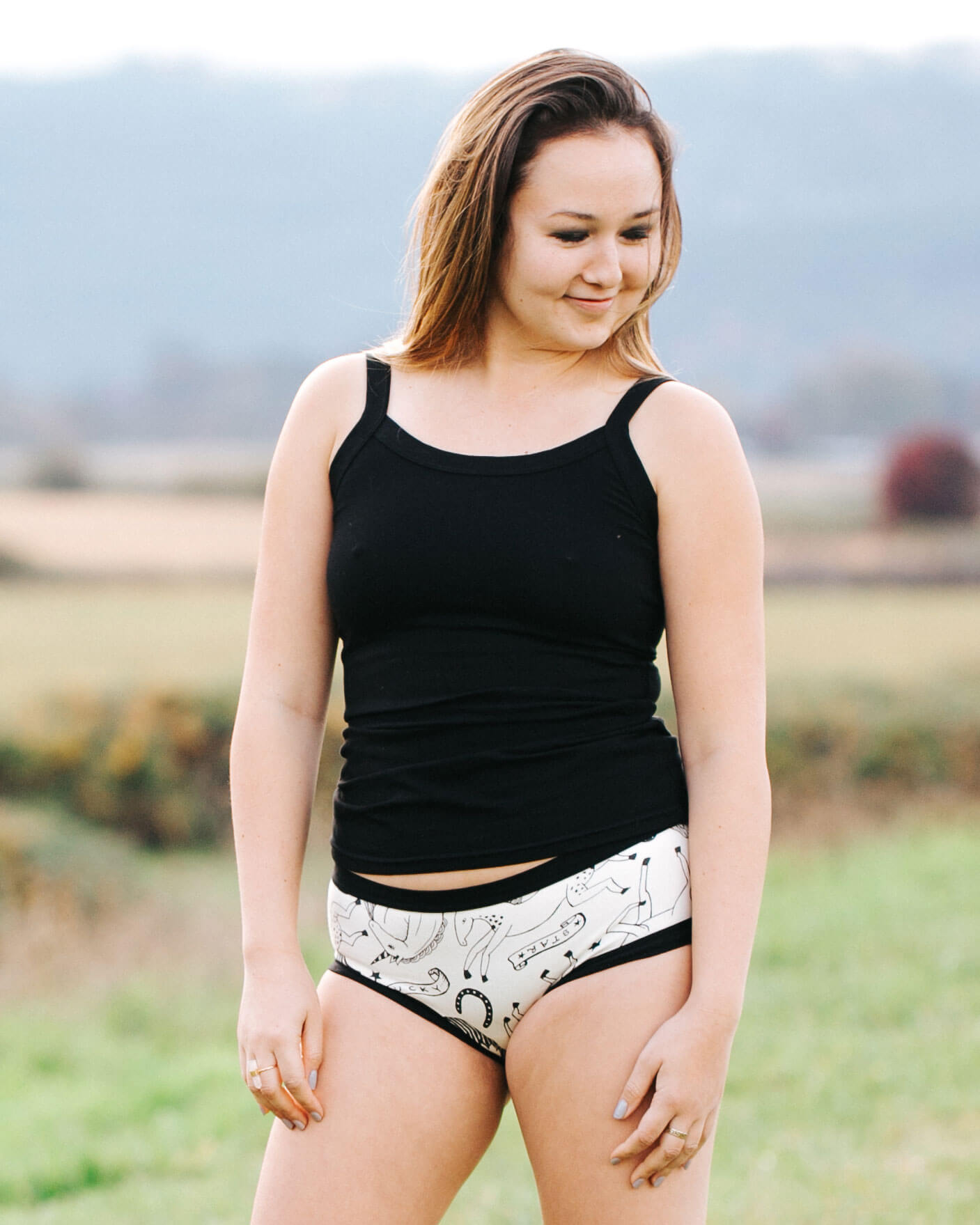 Model outside wearing Thunderpants Camisole in Plain Black and Hipster style underwear in Horses.