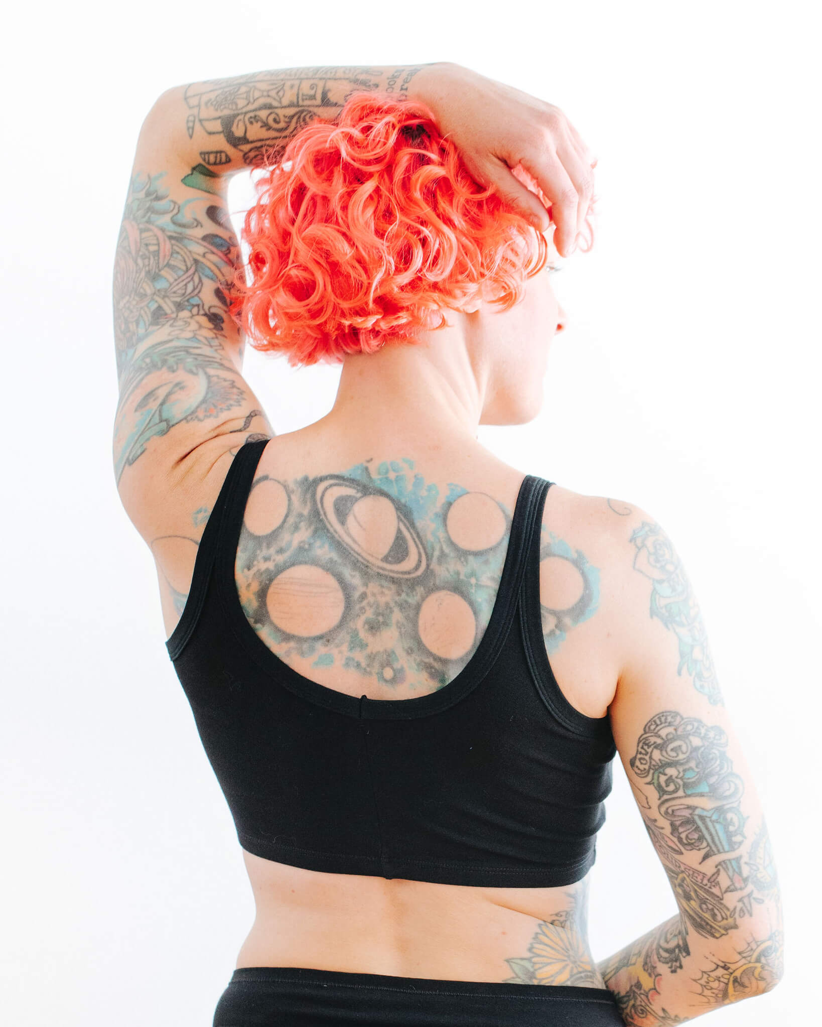 Close up back of model wearing Thunderpants Longline Bra in Black.