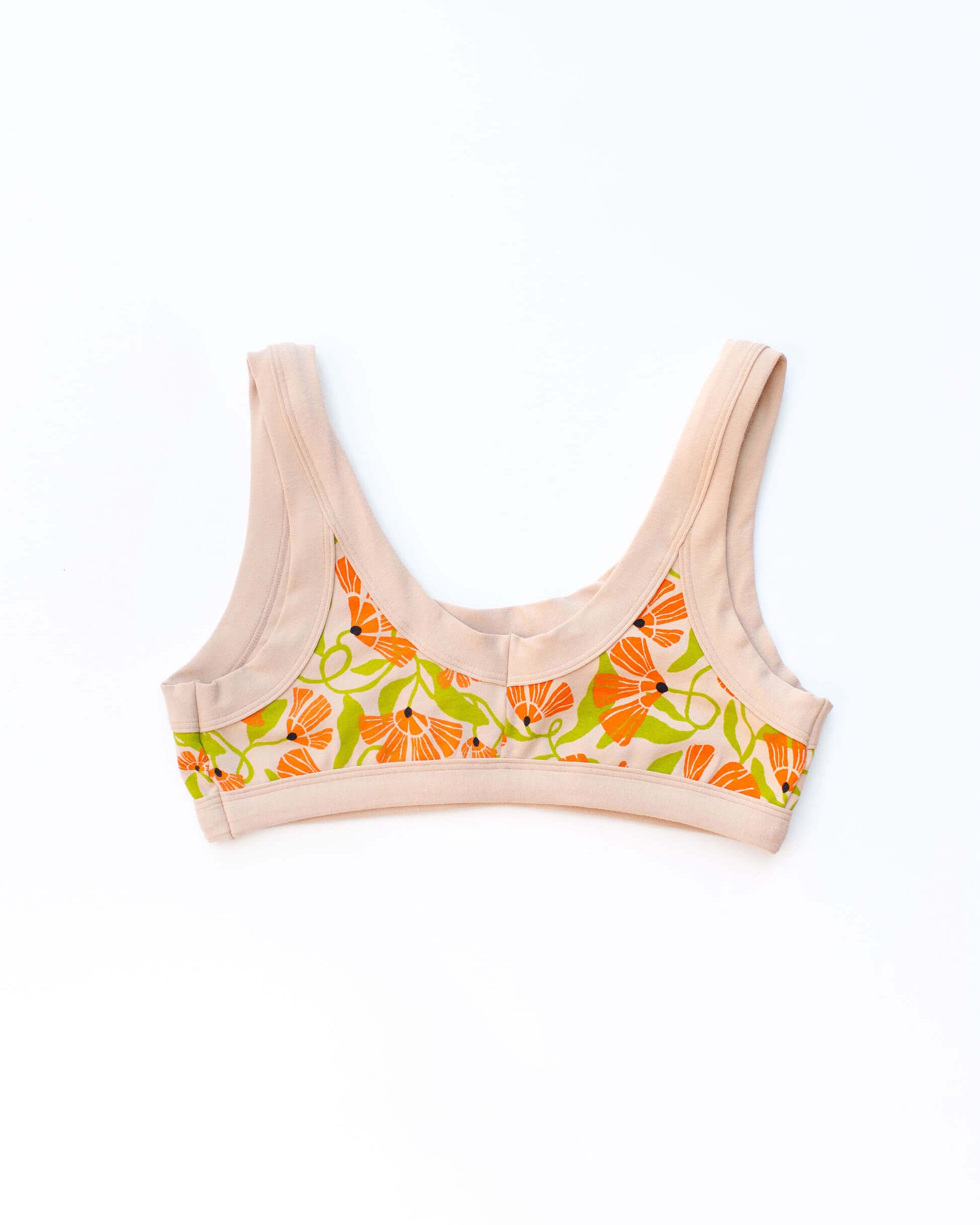 Flat lay of Thunderpants Bralette in Secret Garden print - orange and green flowers on tan.