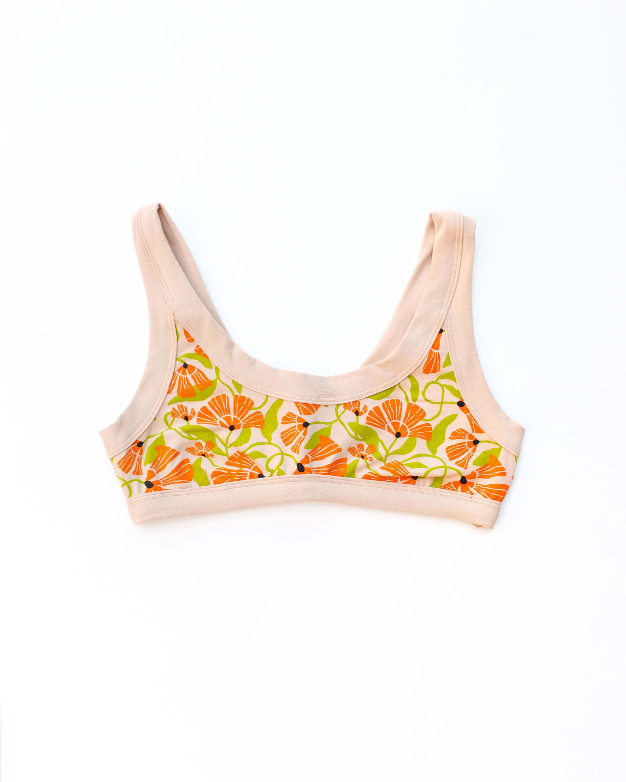 Flat lay of Thunderpants Bralette in Secret Garden print - orange and green flowers on tan.