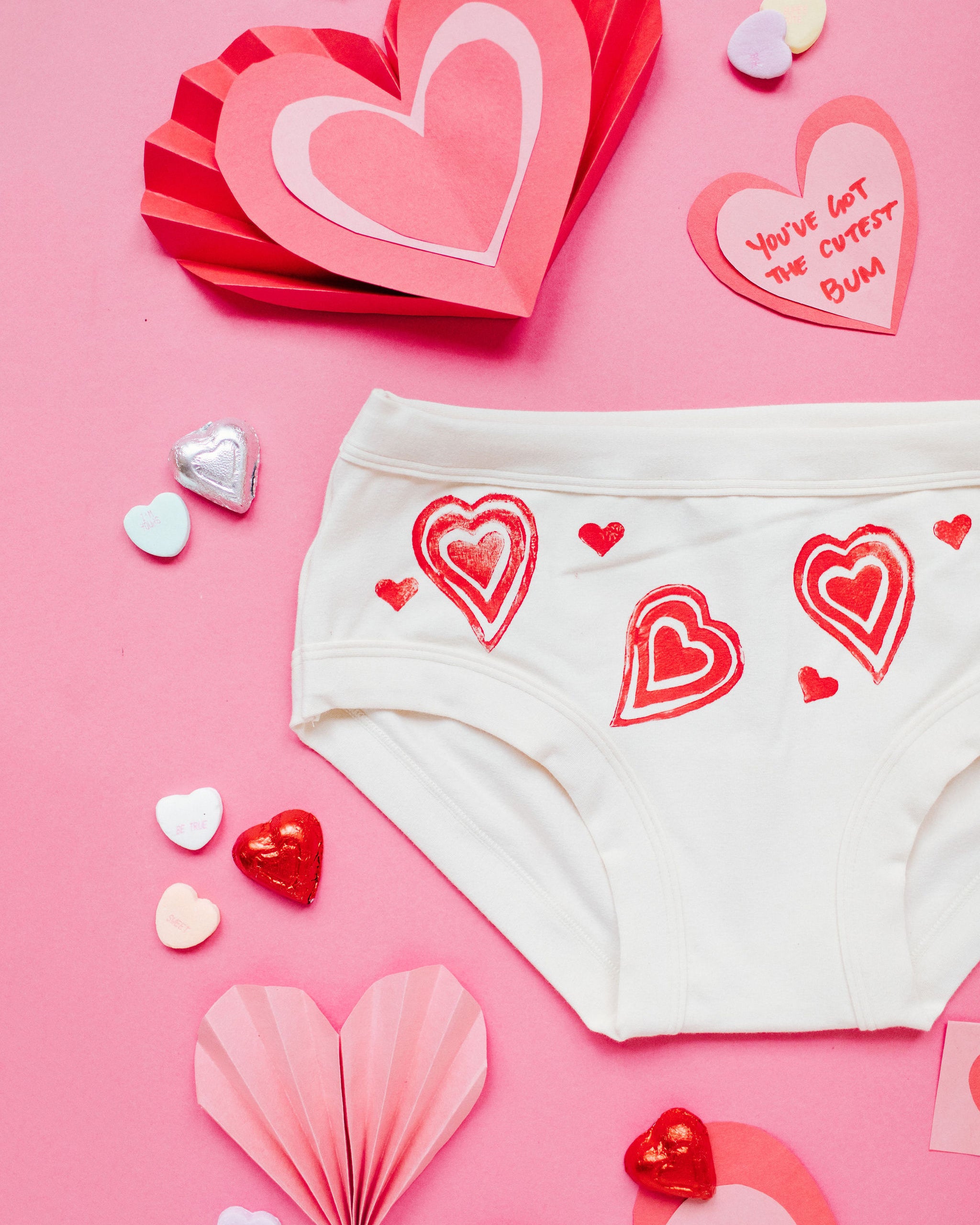 Close up flat lay of Thunderpants Hipster style underwear with hand printed red hearts on Vanilla.