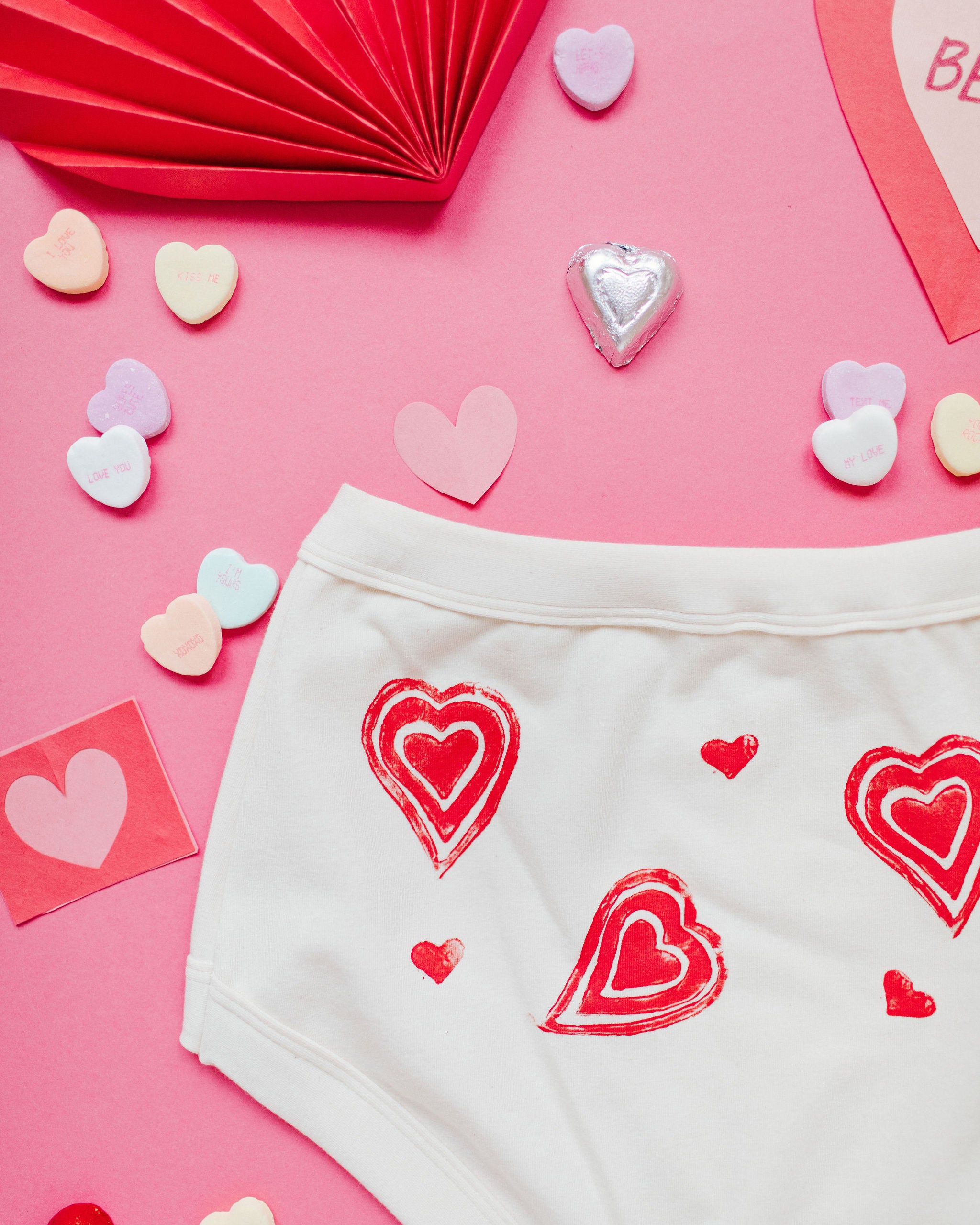 Close up flat lay of Thunderpants Original style underwear with hand printed red hearts on Vanilla.