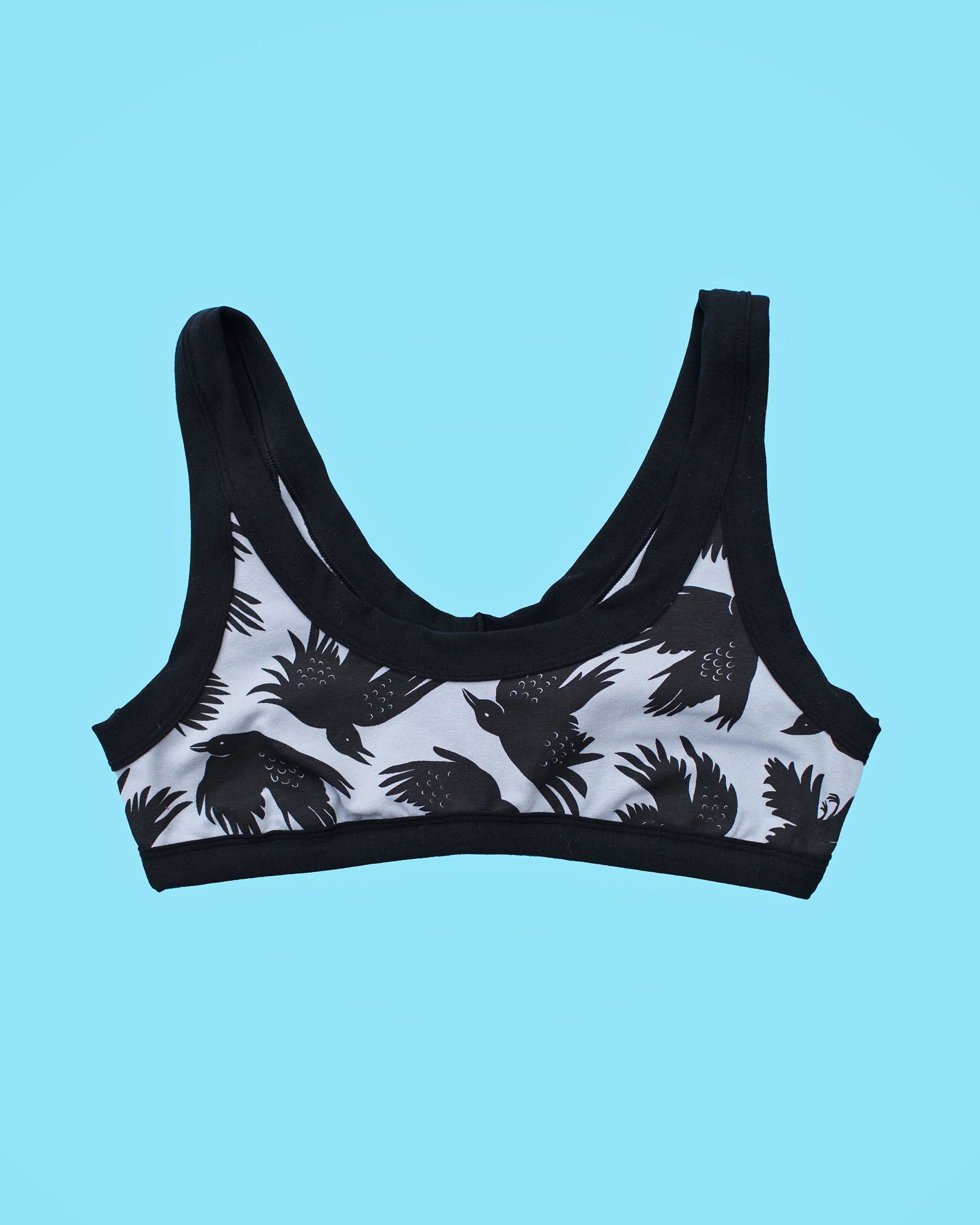 Flatlay of Thunderpants Bralette in So it Crows - black birds on grey.