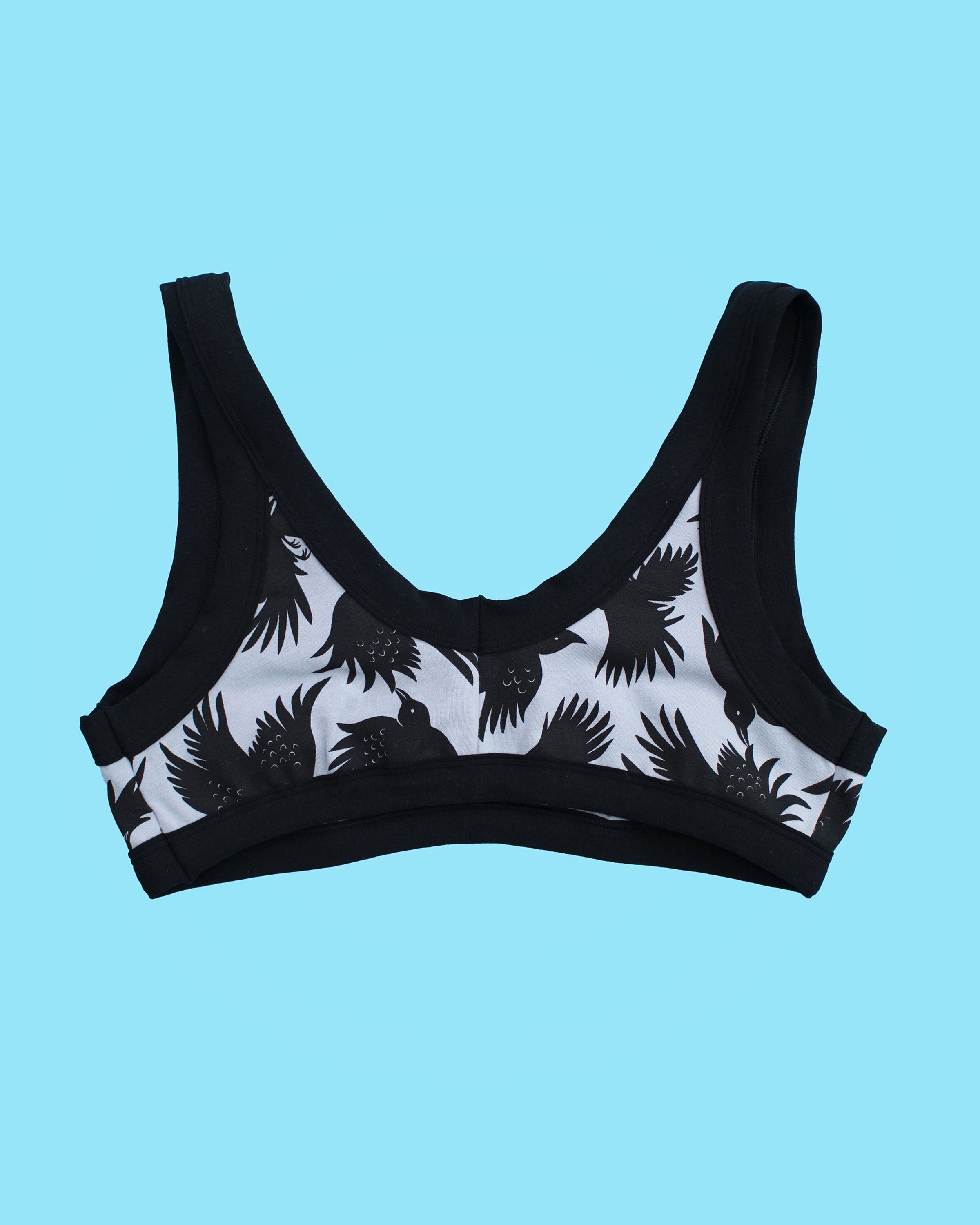 Flatlay of Thunderpants Bralette in So it Crows - black birds on grey.