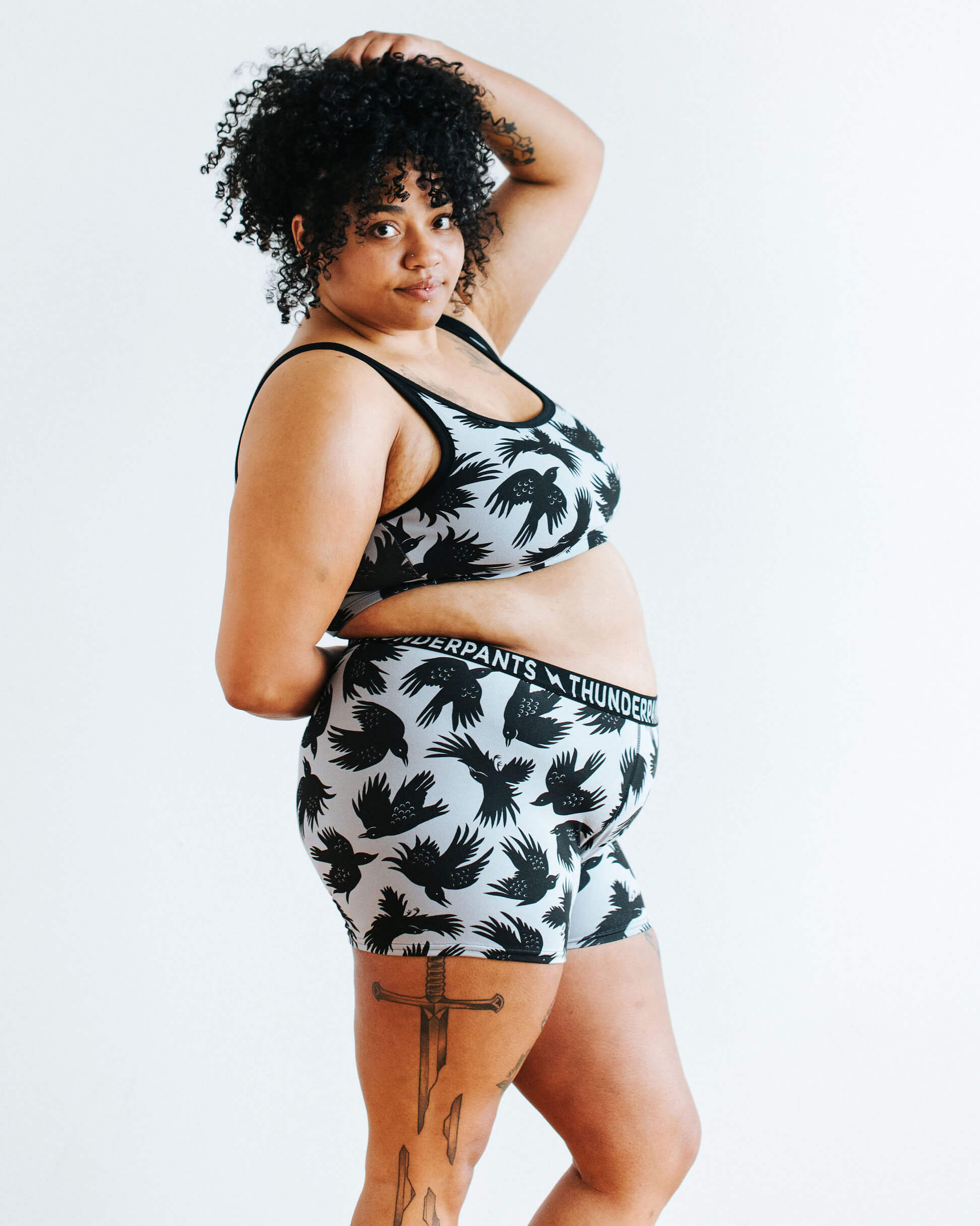 Model wearing Thunderpants Longline Bra and Boxer Brief style underwear in So it Crows - black crows on grey.