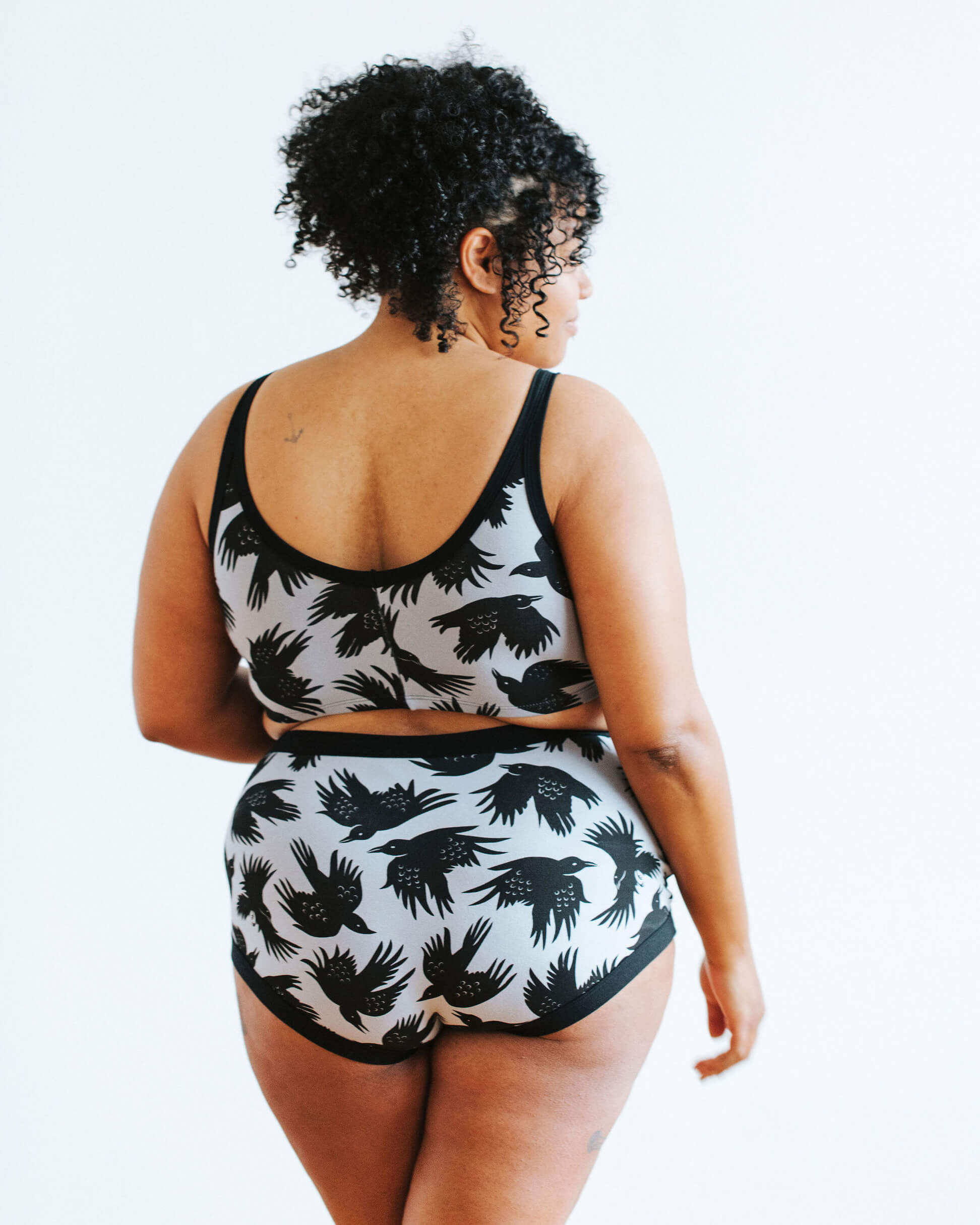 Model wearing Thunderpants Longline Bra and Sky Rise style underwear in So it Crows - black crows on grey.
