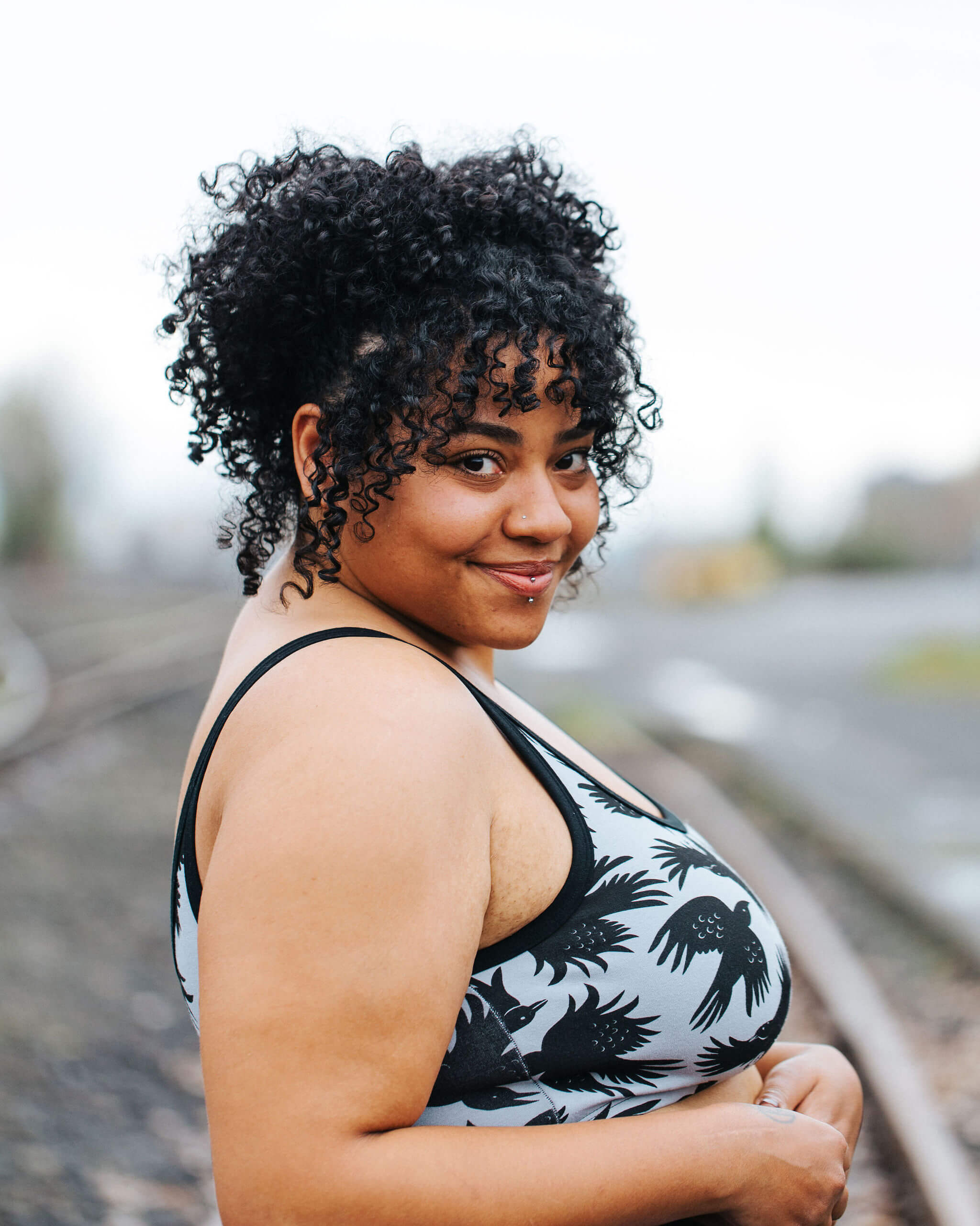 Model wearing Thunderpants Longline Bra in So it Crows - black crows on grey.