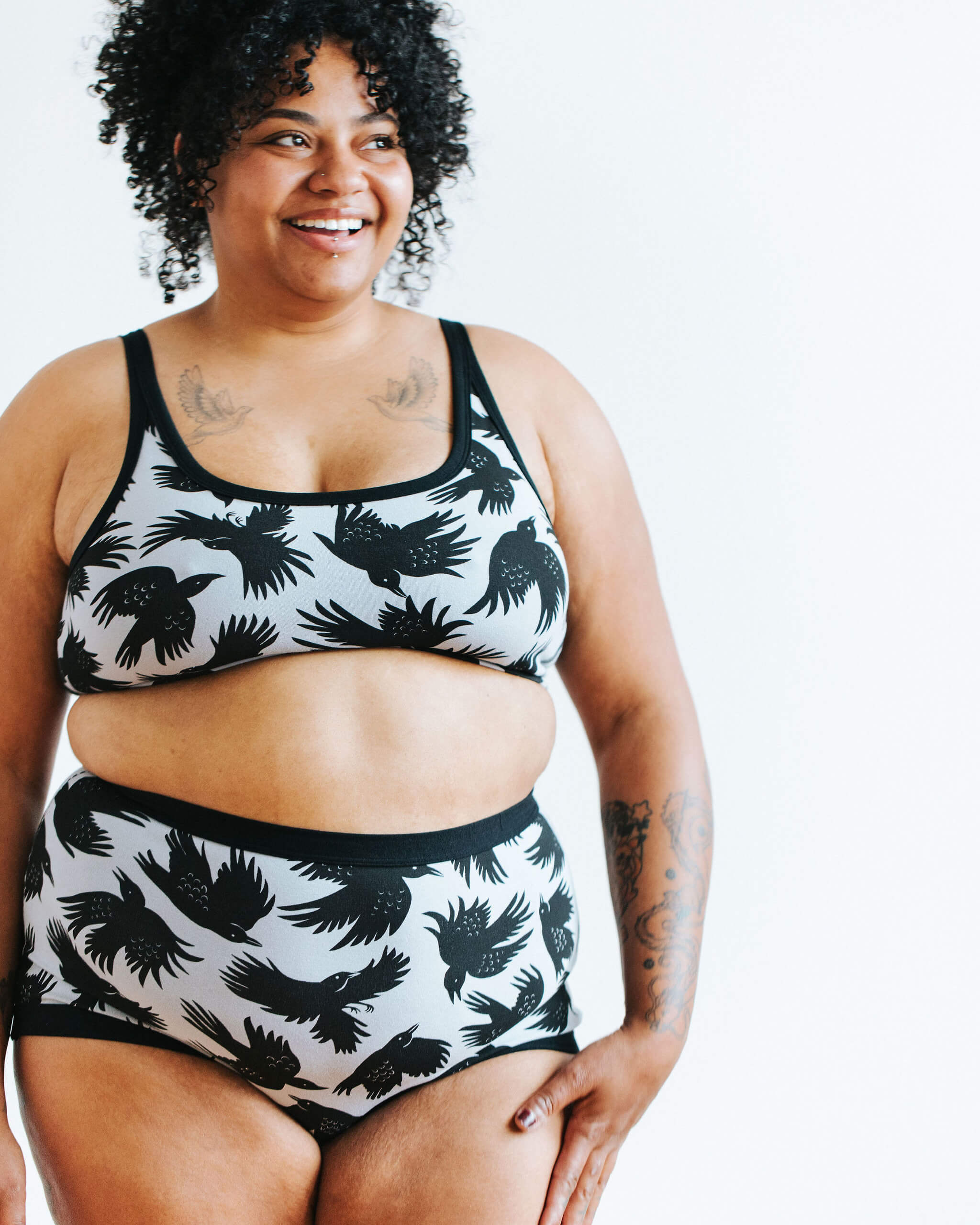 Model wearing Thunderpants Sky Rise style underwear and Longline Bra in So it Crows - black crows in grey.
