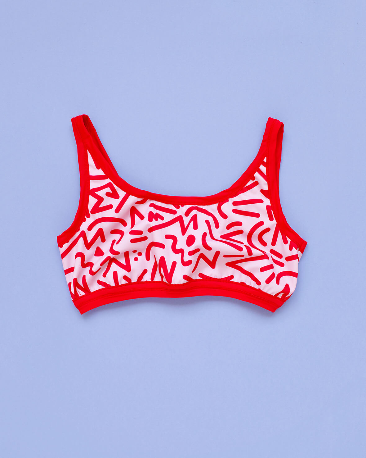 Flat lay of Thunderpants Swim Top in Energy Vibes print: light pink with dark pink designs.