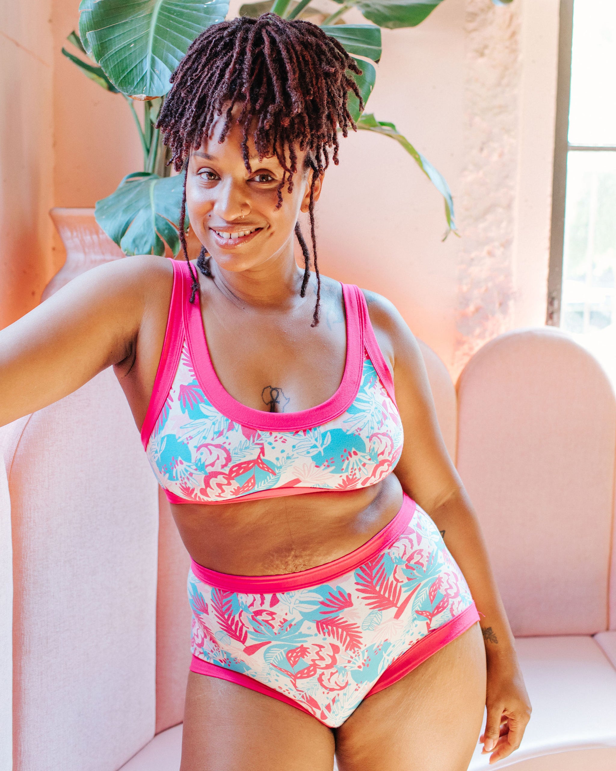 Model wearing a set of Thunderpants Original style underwear and Bralette in Finding Flamingos - pink and blue Miami-inspired print.
