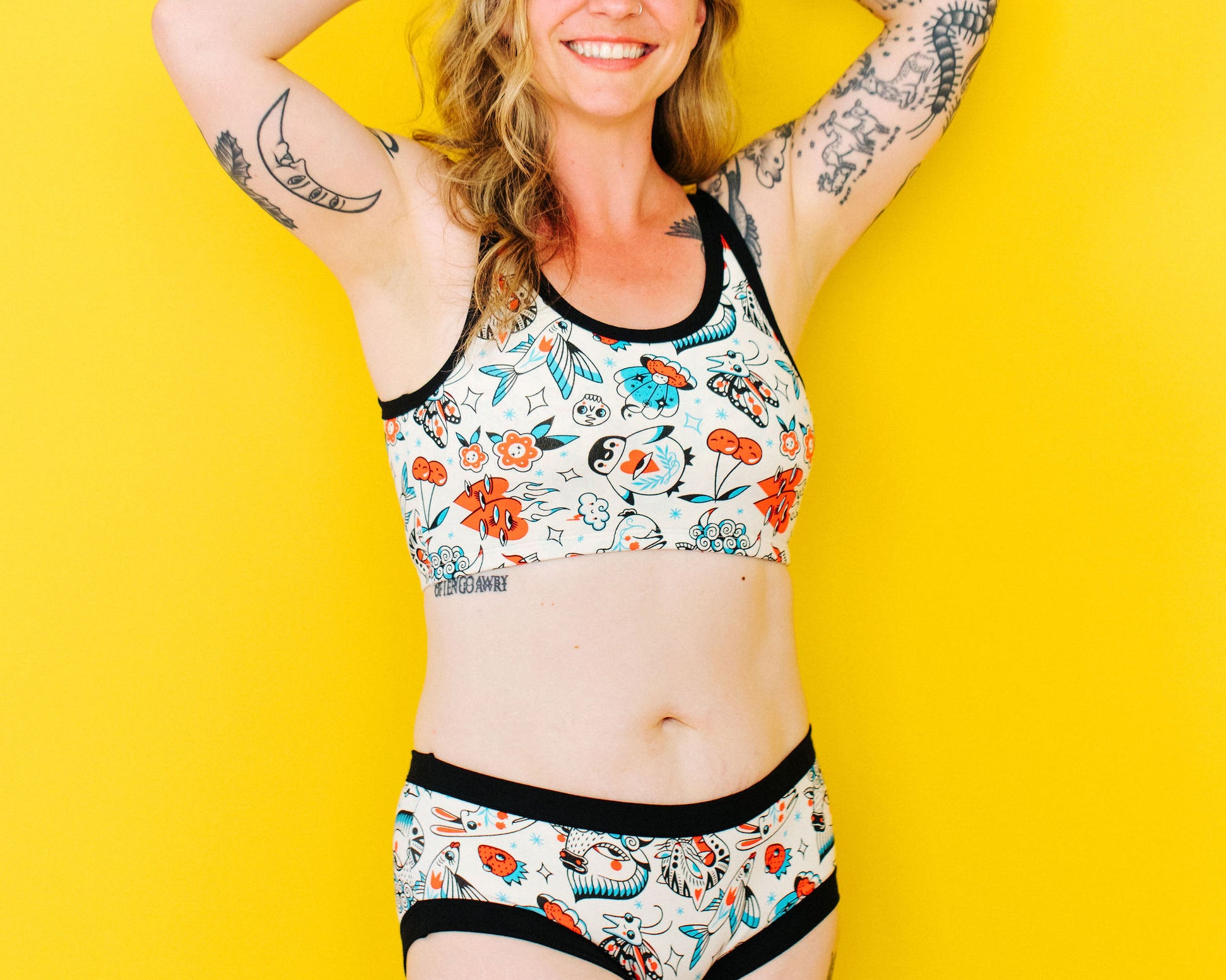 Model wearing Thunderpants Hipster style underwear and Longline Bra in Inked Up - a tattoo pattern with black, red, and blue.