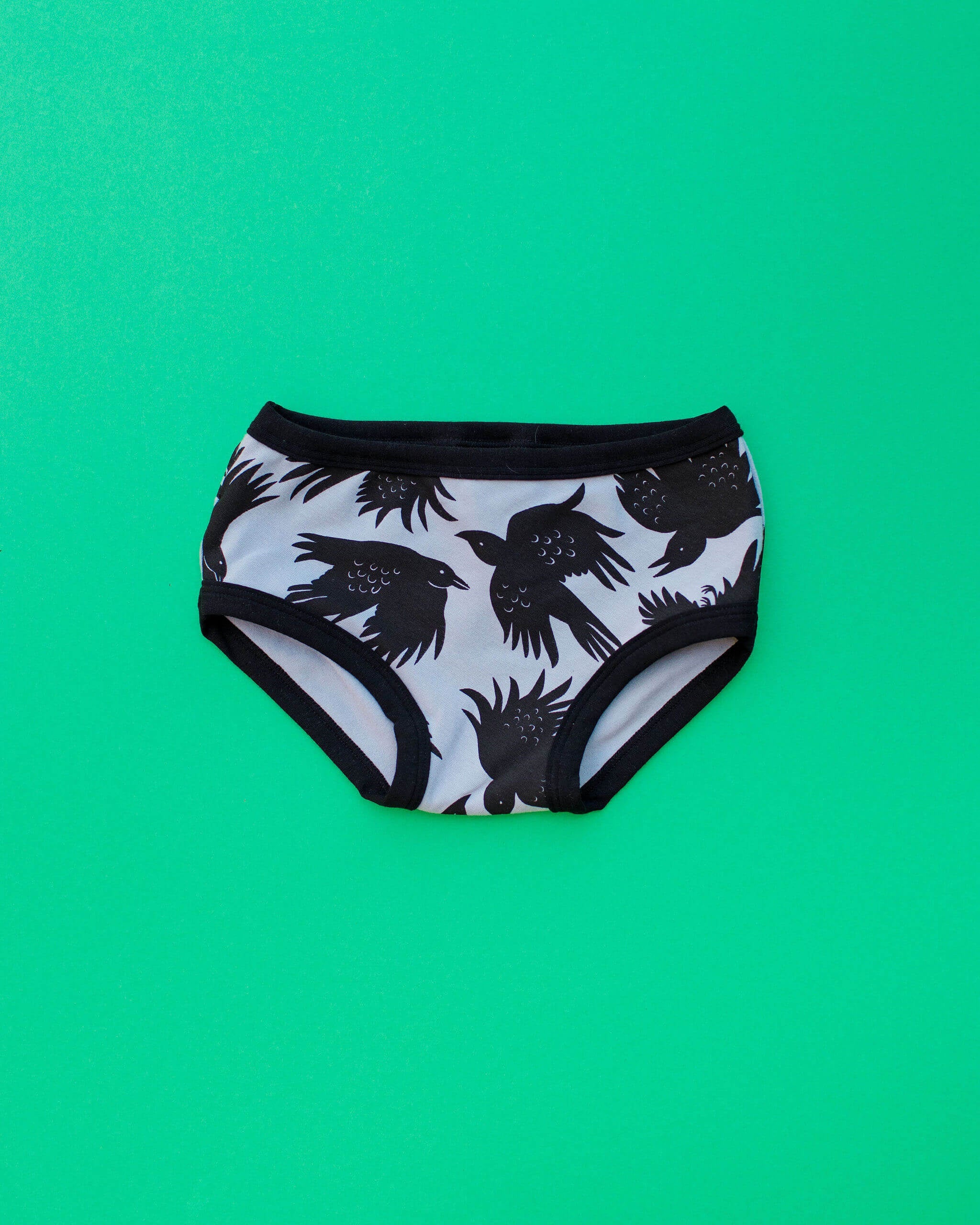 Flat lay of Thunderpants Kid's style underwear in So it Crows - grey with black crows.