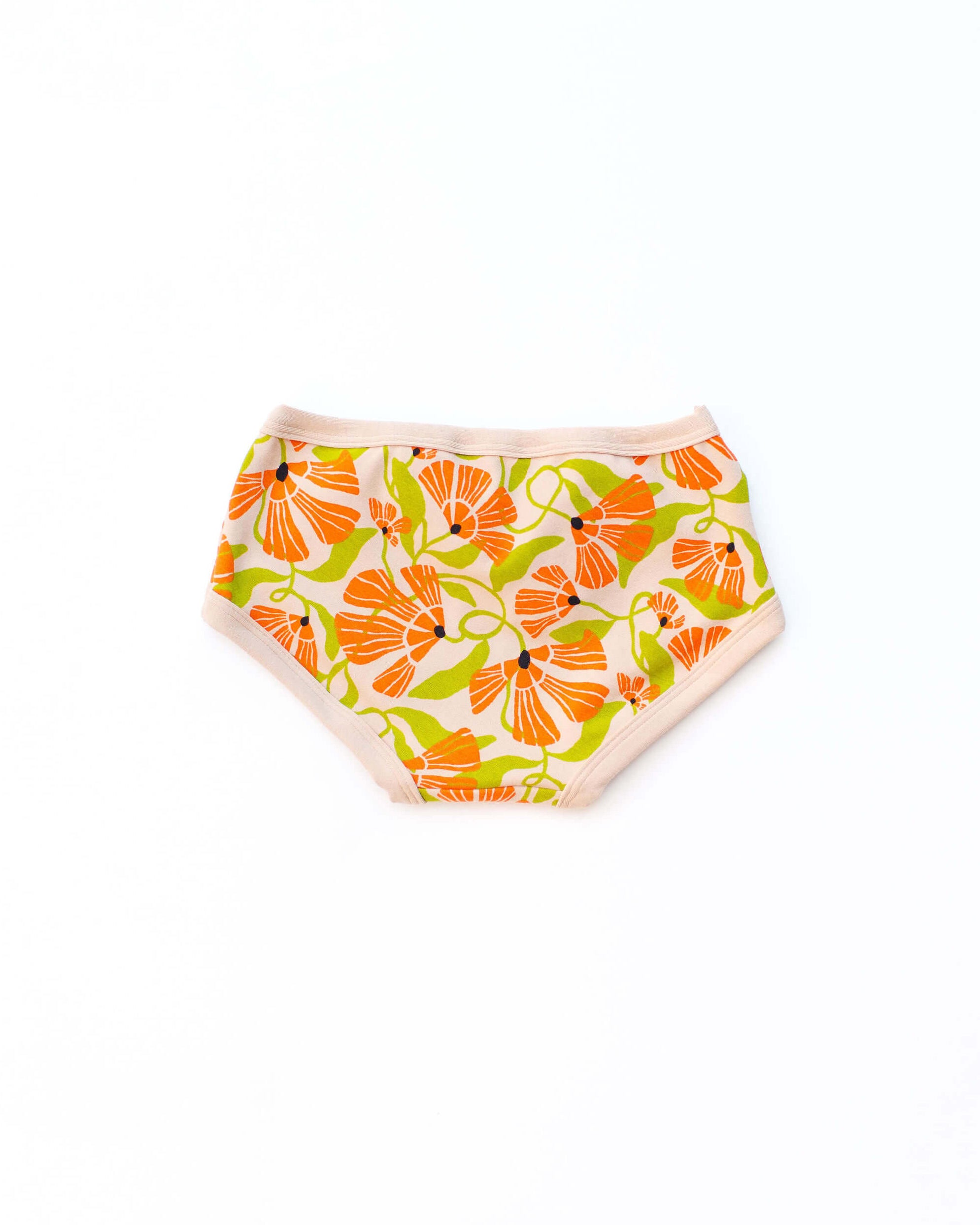Flat lay of Thunderpants Kid's style underwear in Secret Garden - orange and green flowers.