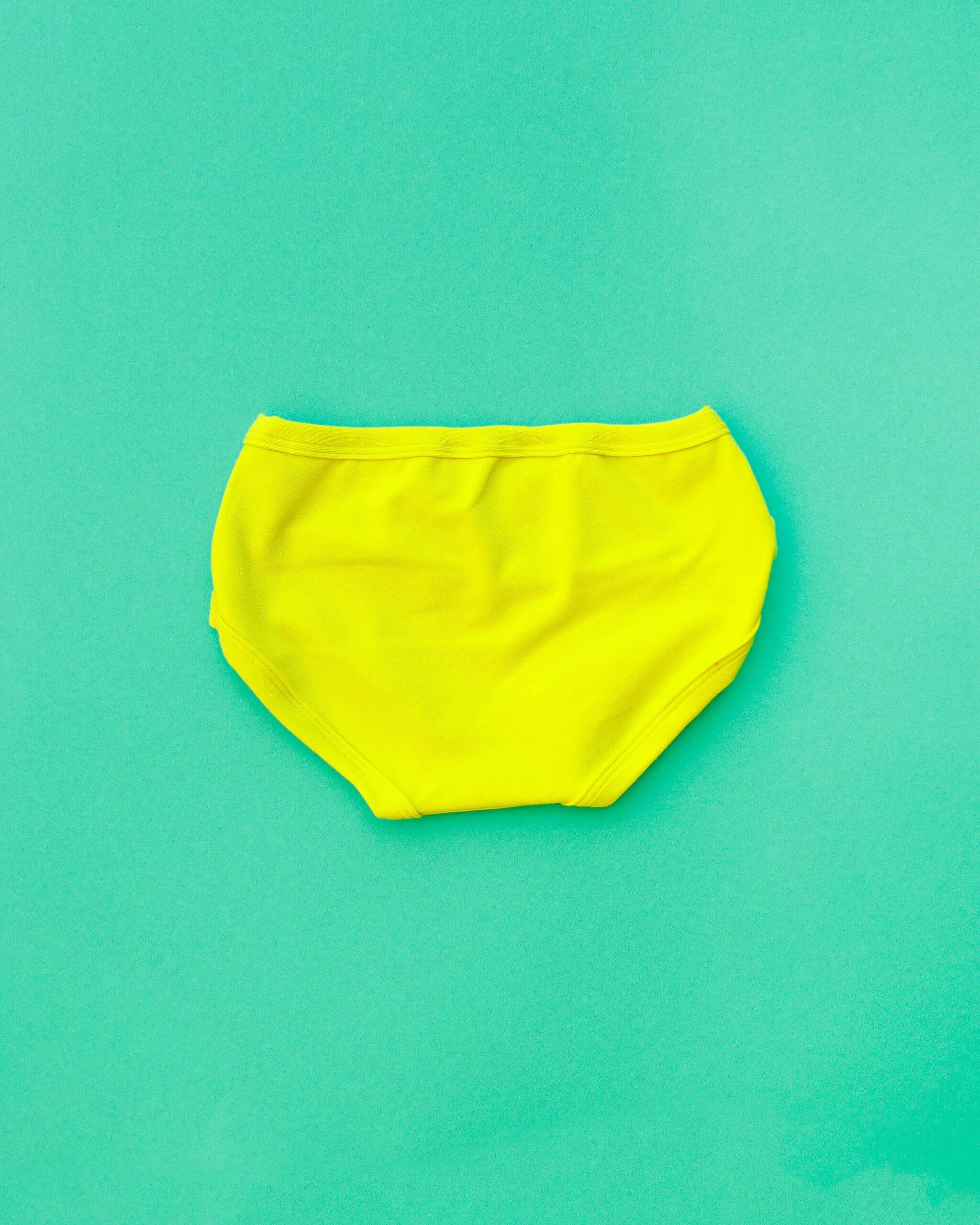 Flat lay of Thunderpants Kid's style underwear in Star Fruit - a yellow chartreuse color.