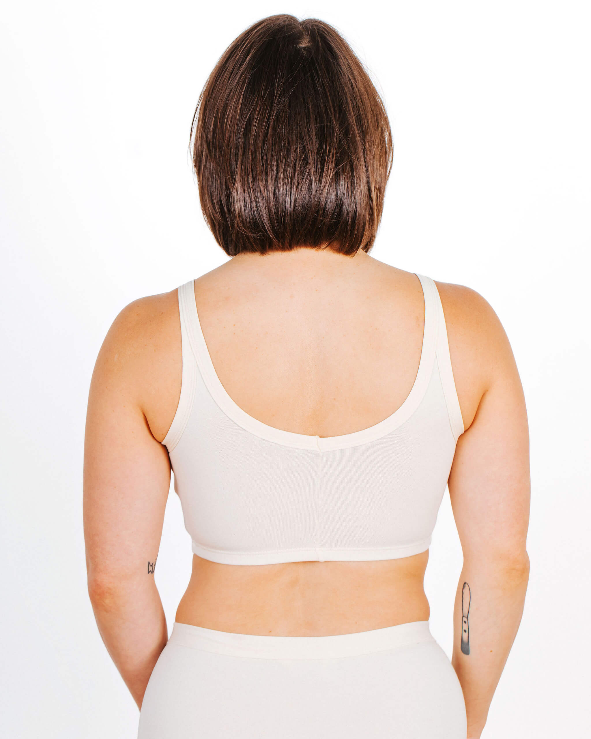 Fit photo from the back of Thunderpants organic cotton Longline Bra in off-white on a model.