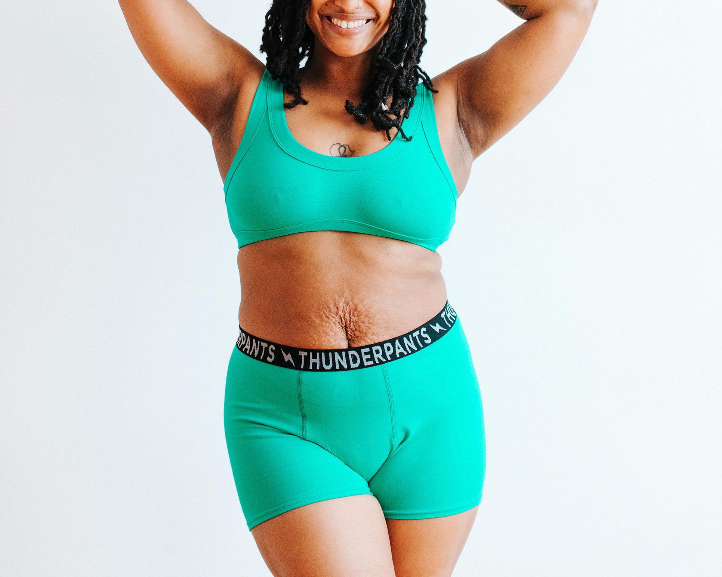 Model wearing Thunderpants Boxer Brief style underwear and Bralette in Peacock Green.