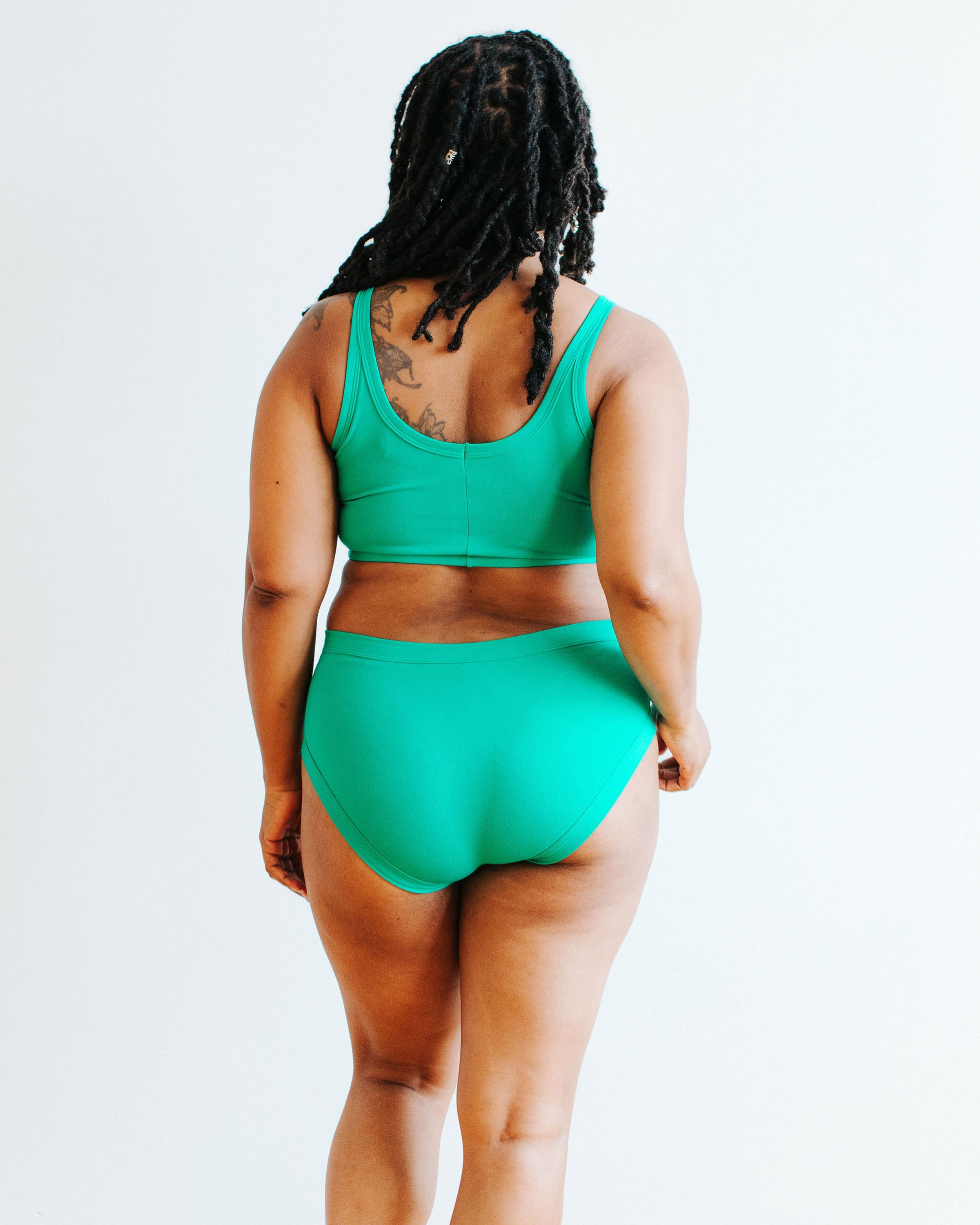 Model wearing Thunderpants Hipster style underwear and Longline Bra in Peacock Green.