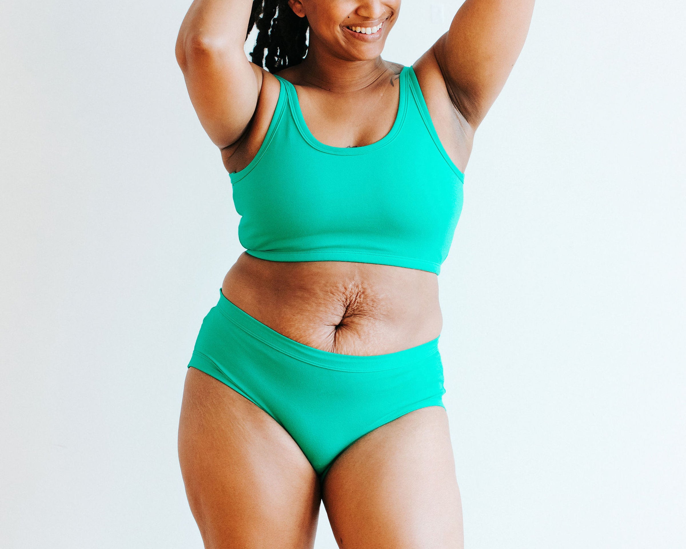 Model wearing Thunderpants Hipster style underwear and Longline Bra in Peacock Green.