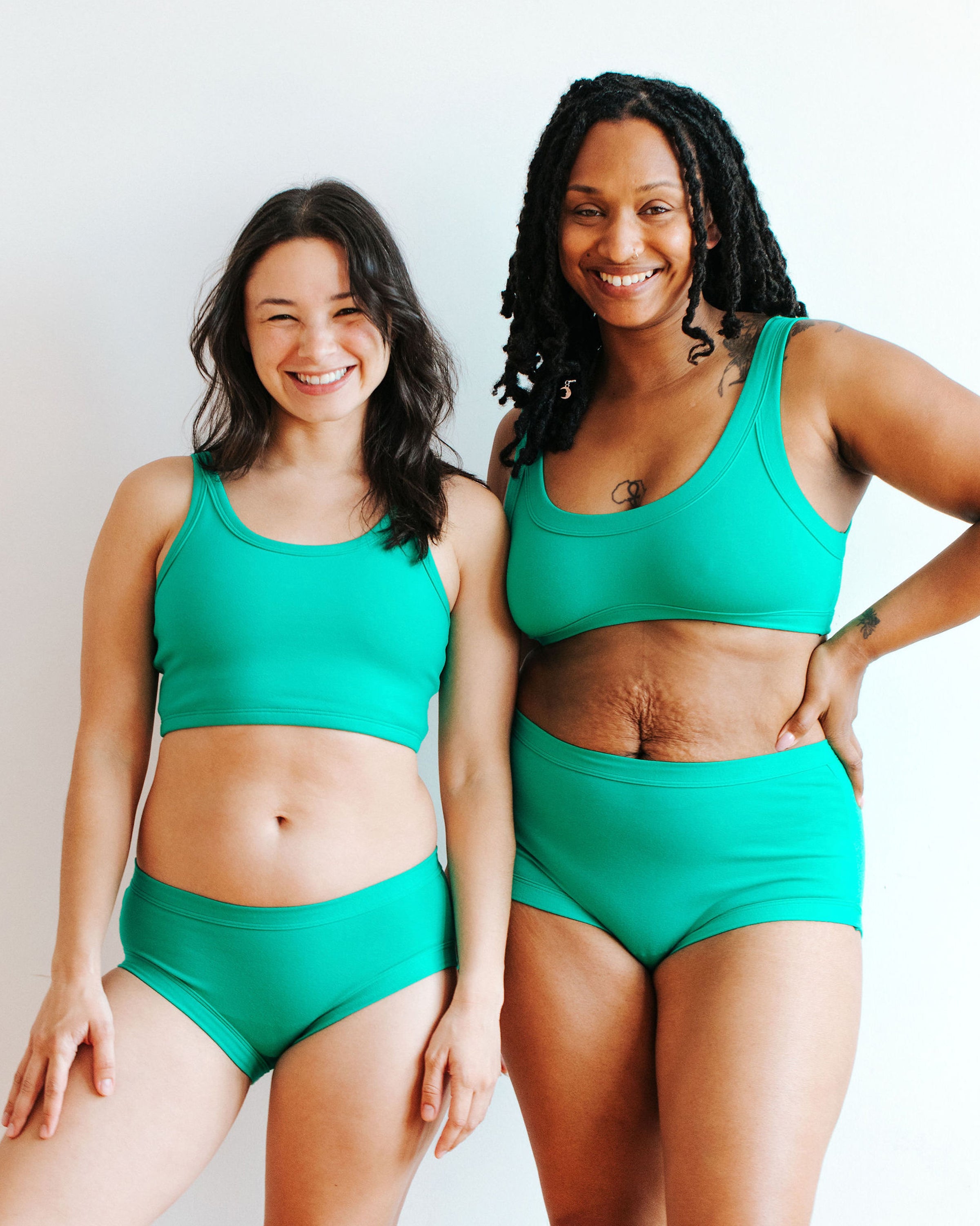 Two models wearing various styles of Thunderpants in Peacock Green.
