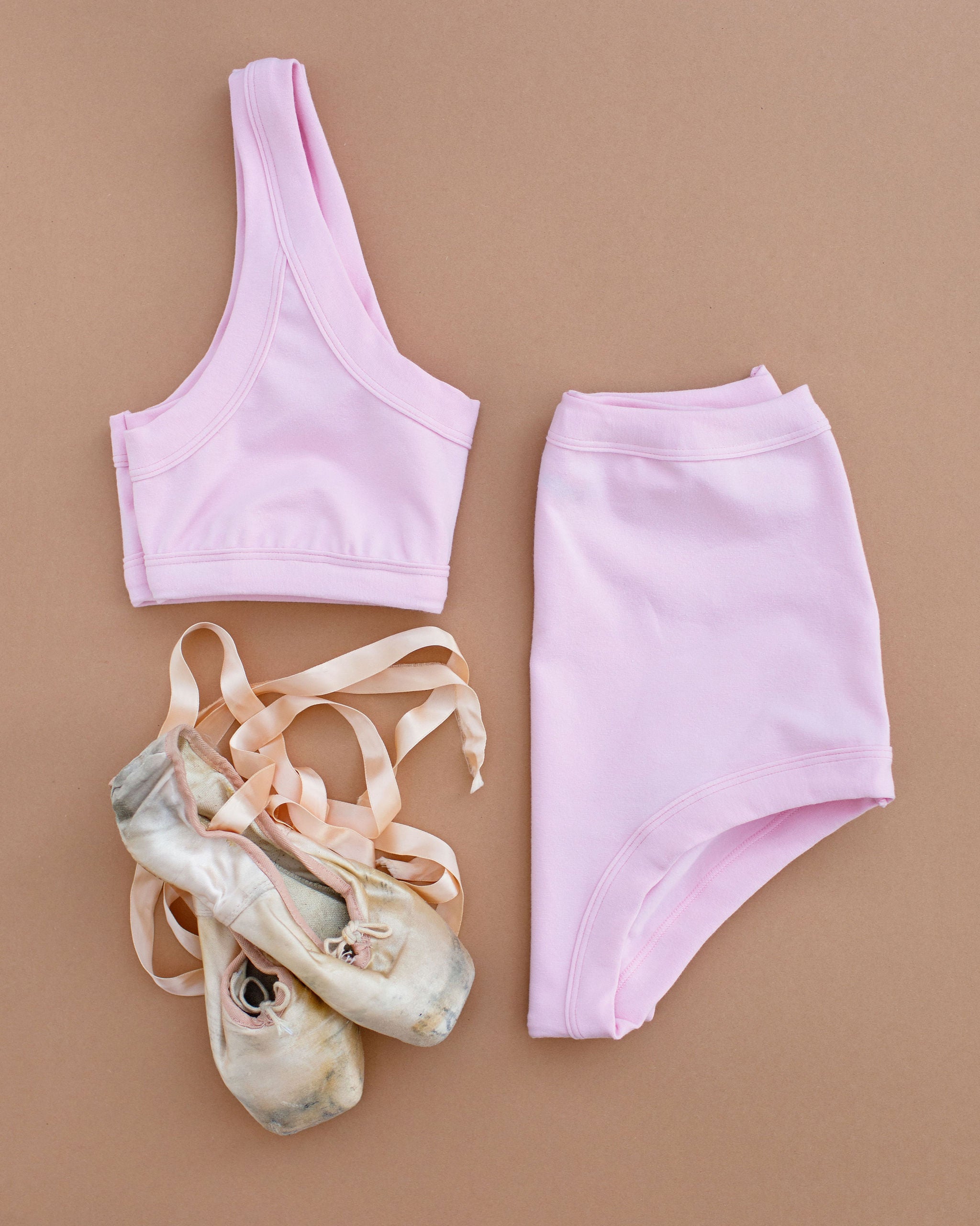 Flat lay of Thunderpants Bralette and Sky Rise style underwear in Plié Pink - light pink color.
