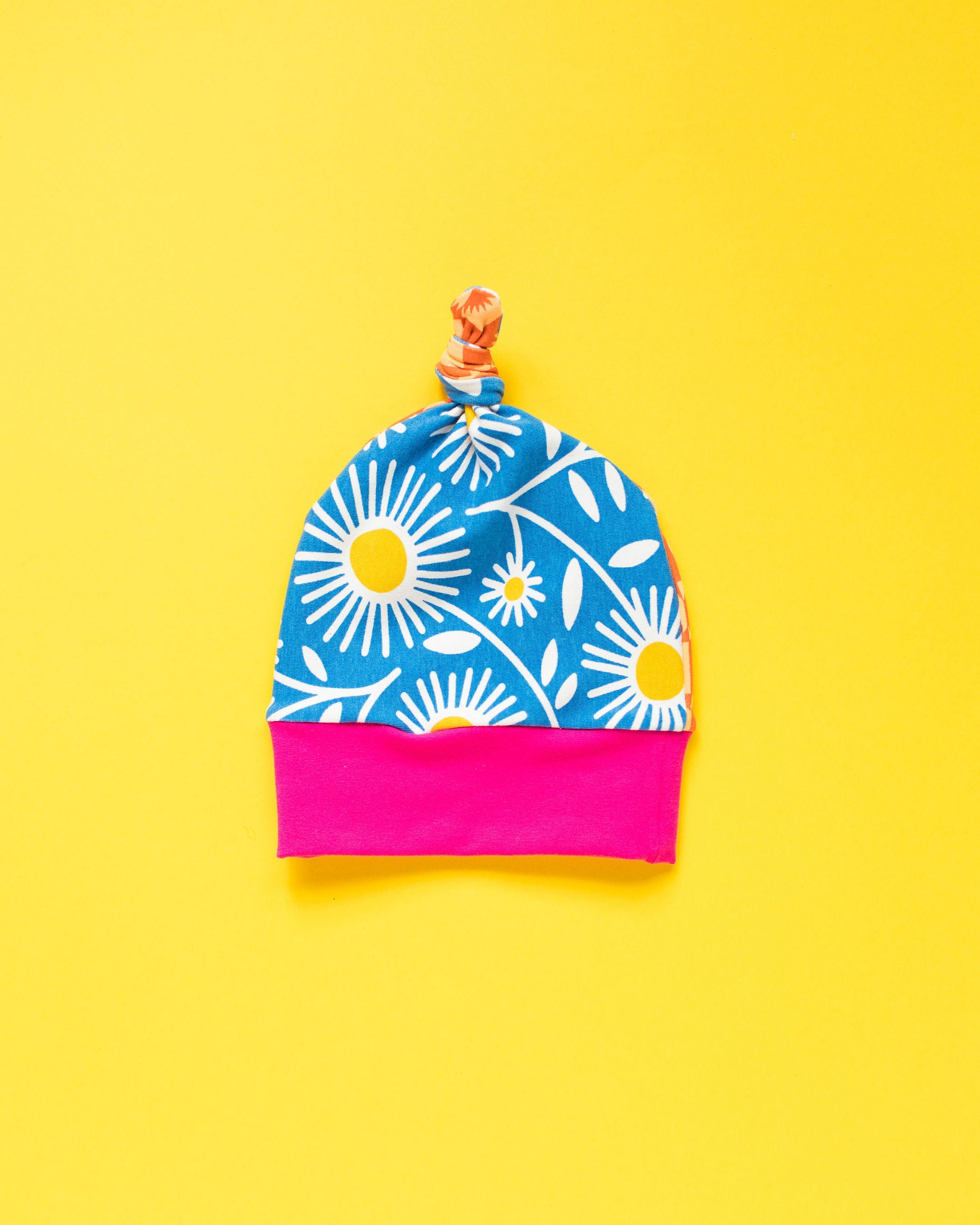 Flat lay of one Thunderpants Scrap Baby Hat - multiple colors and prints.