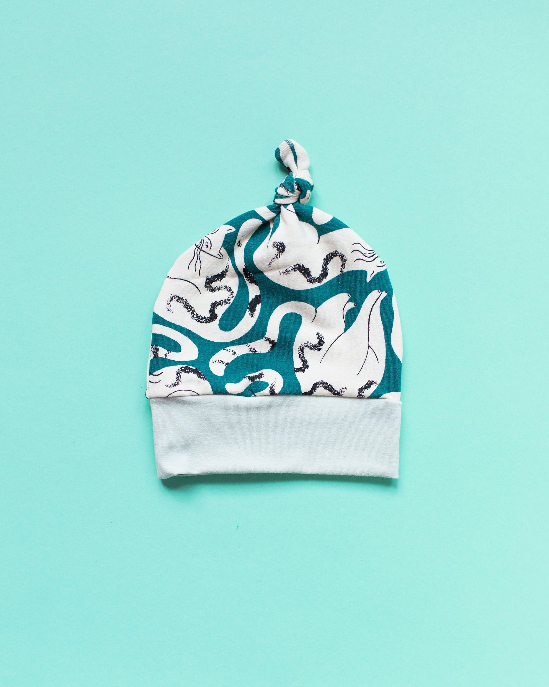 Flat lay of one Thunderpants Scrap Baby Hat - multiple colors and prints.