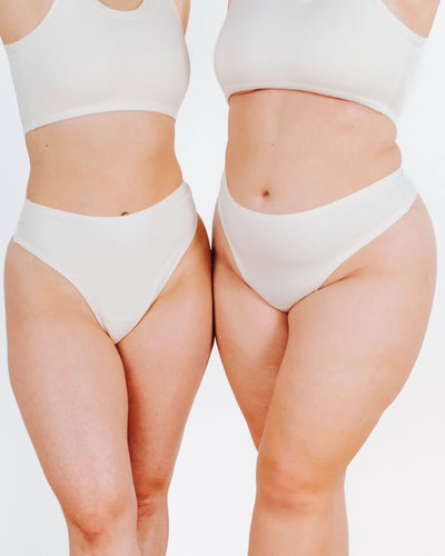 Fit photo of two models in Thunderpants organic cotton Thong style underwear in Plain Vanilla.