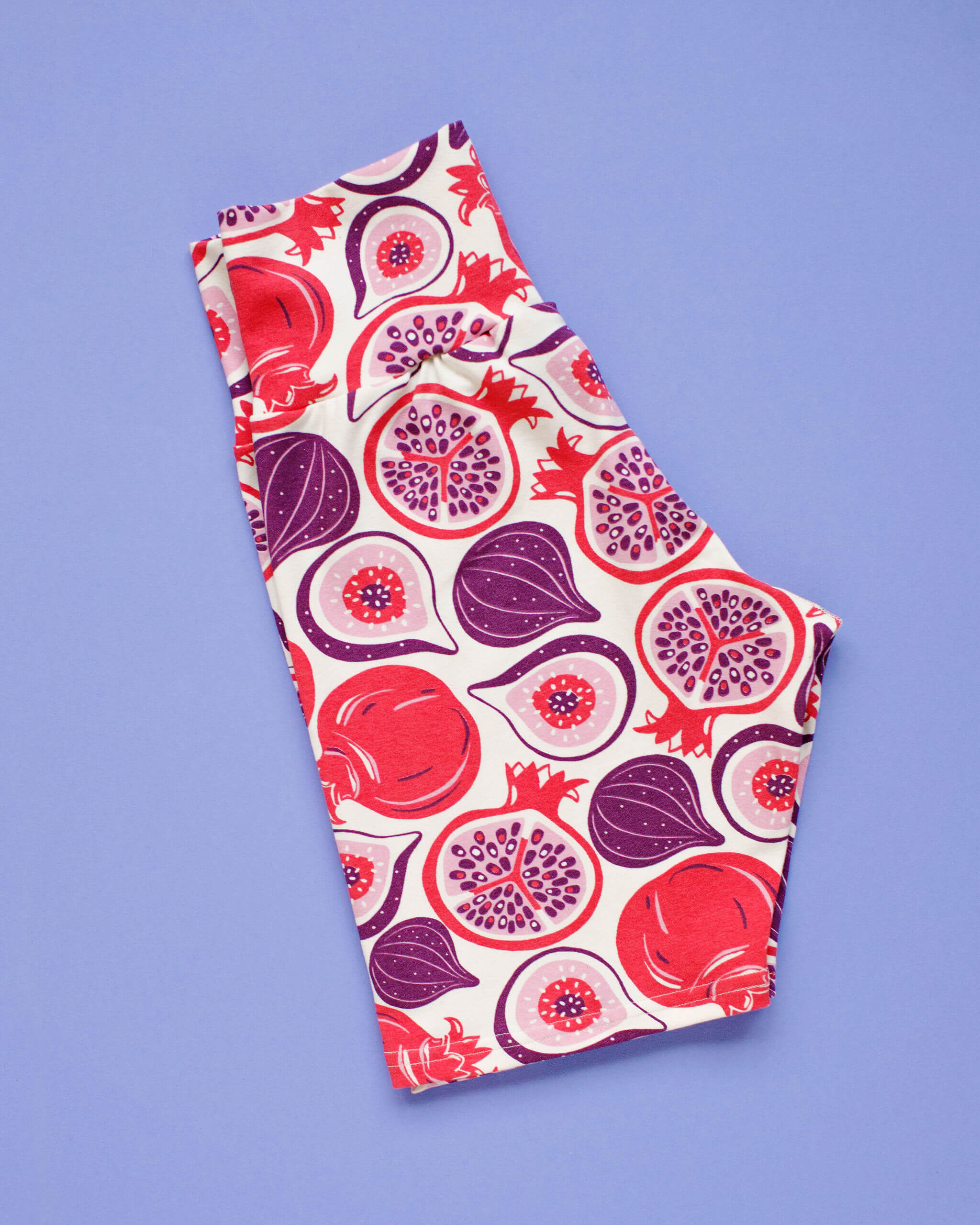 Flat lay of Thunderpants Bike Shorts in Two Fruits print - figs and pomegranates.