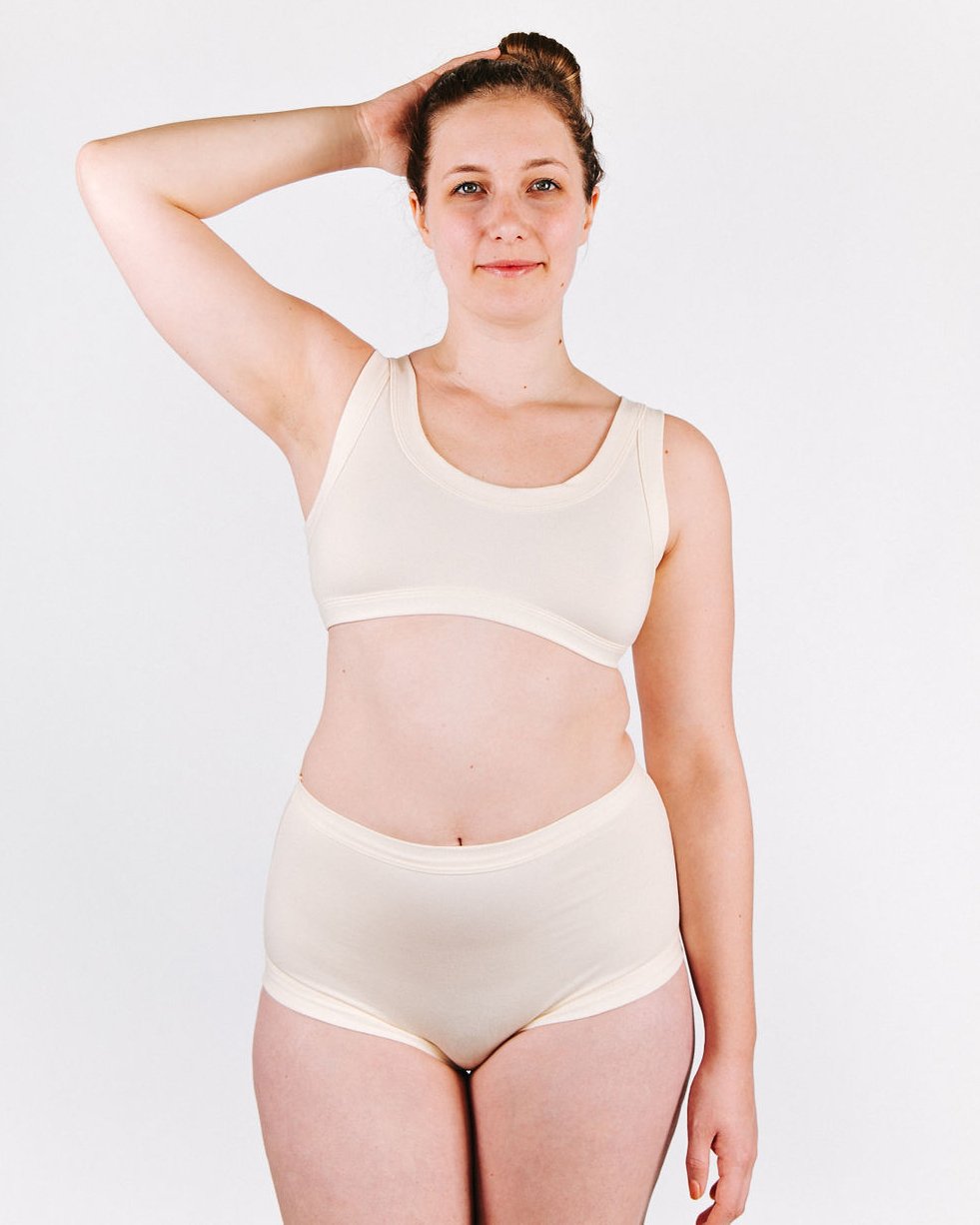 Fit photo from the front of Thunderpants organic cotton Bralette and Women’s Original Style underwear in off-white on a woman.