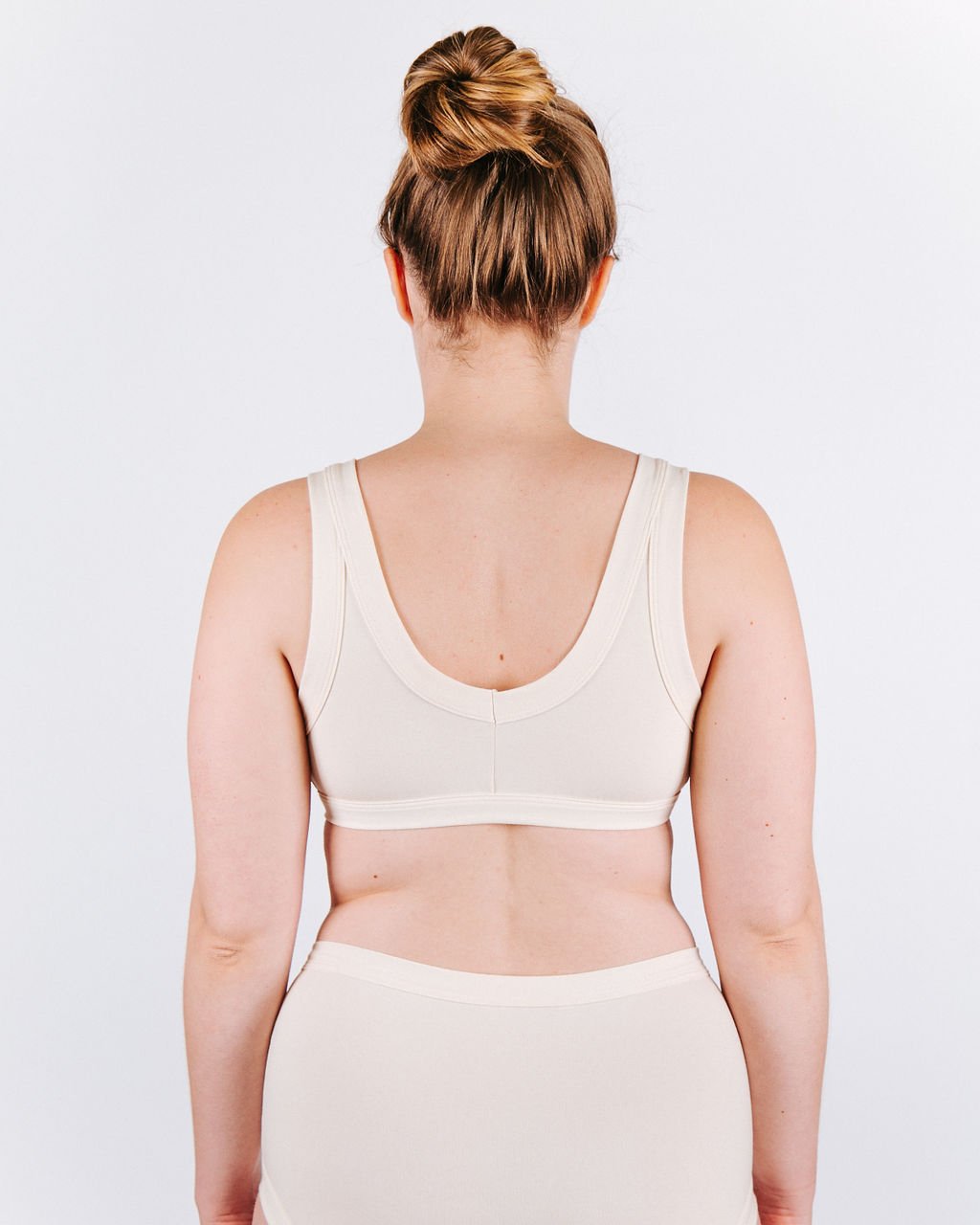 Fit photo from the back of Thunderpants organic cotton Bralette and Women’s Original Style underwear in off-white on a woman.