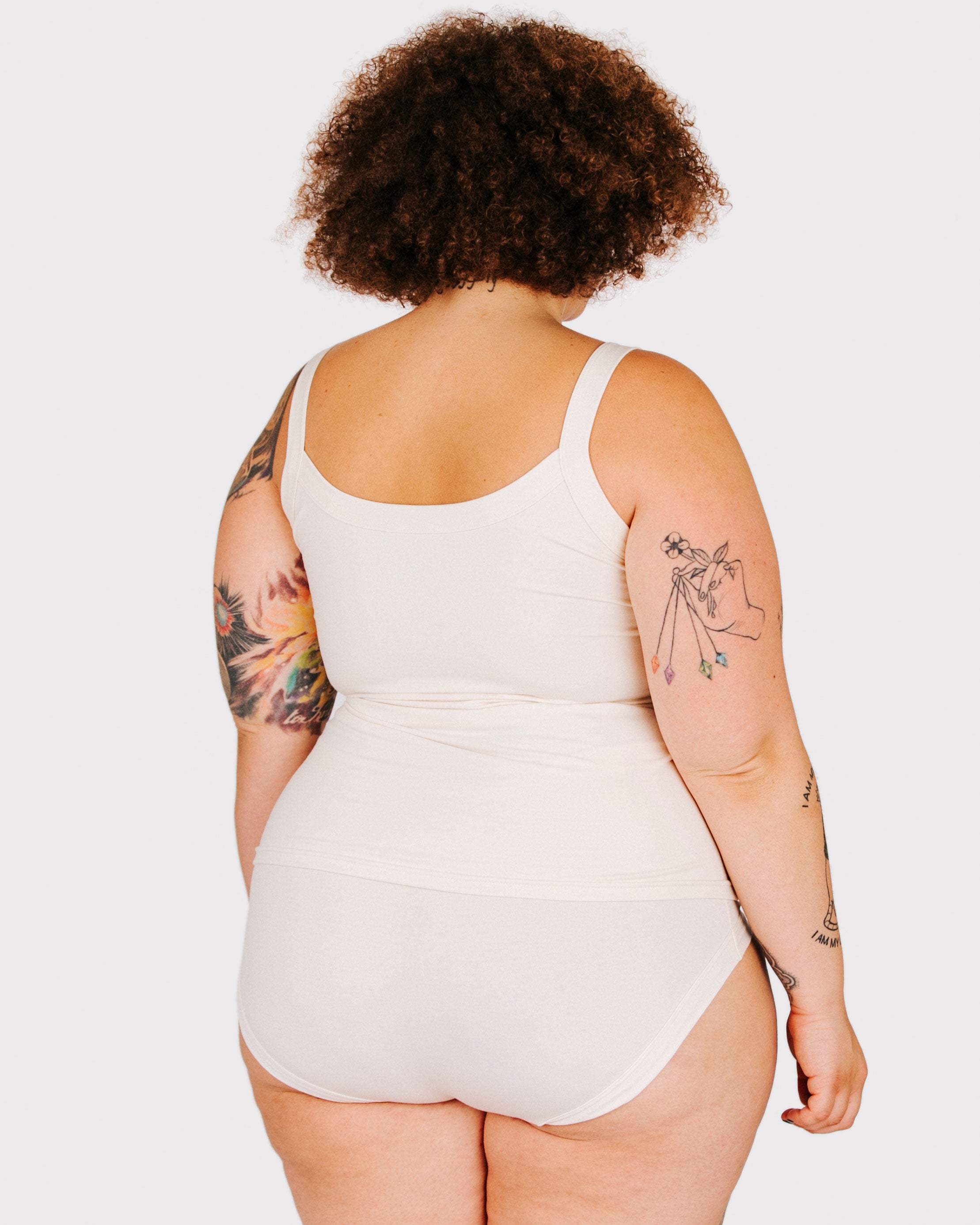 Fit photo from the back of Thunderpants organic cotton Camisole and Hipster style underwear in off-white, showing a wedge-free bum, on a model..