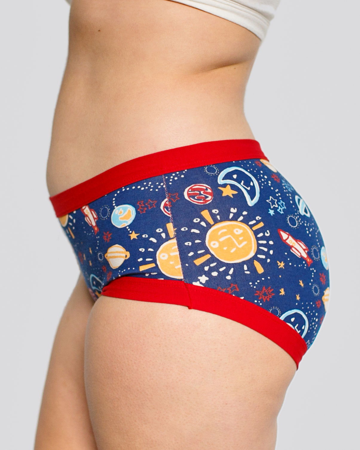 Model's side wearing Thunderpants organic cotton Hipster style underwear in a sun, planets, stars, and universe print.