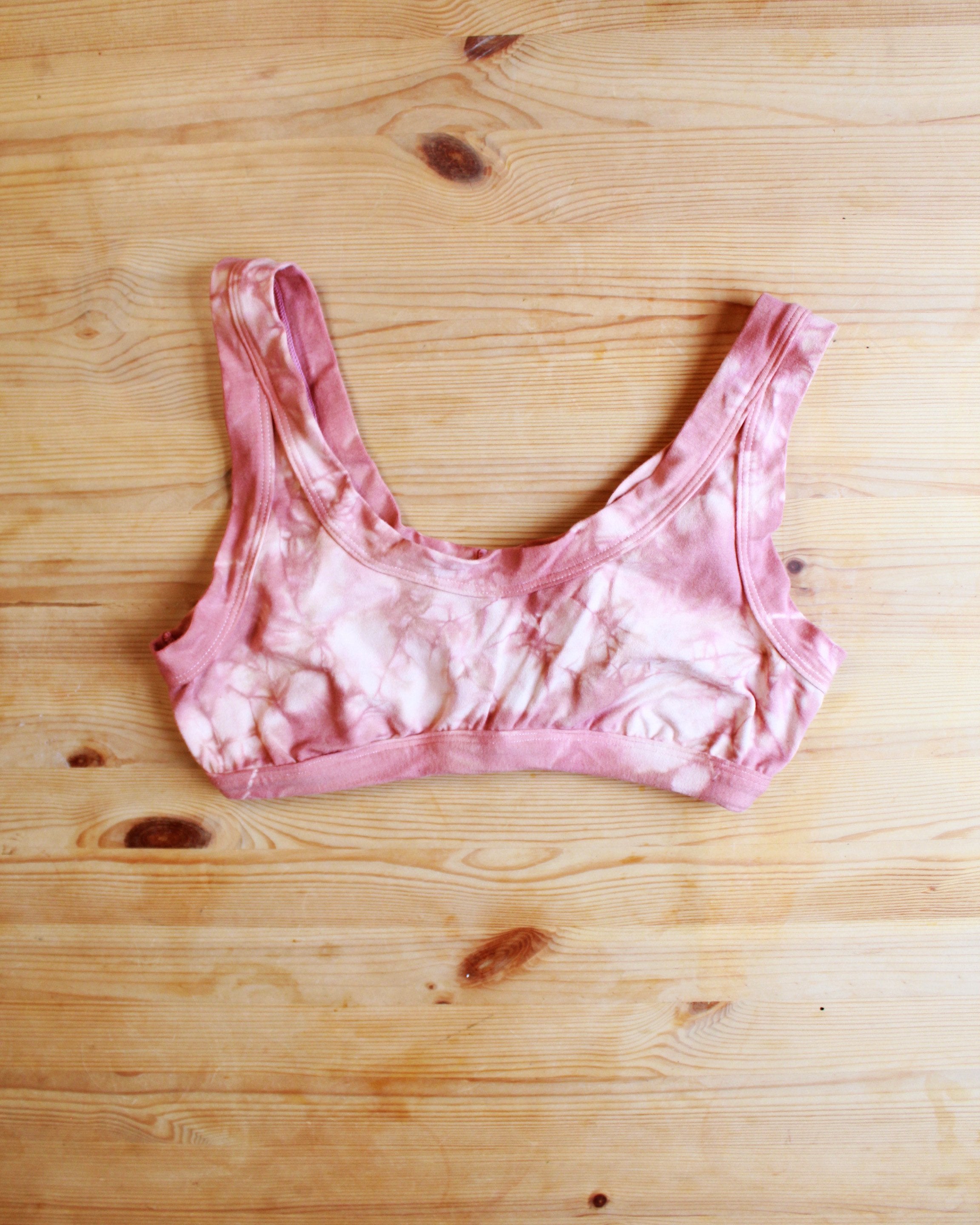 Flat-lay front of Thunderpants organic cotton Bralette in limited edition hand dyed pink shibori tie dye.