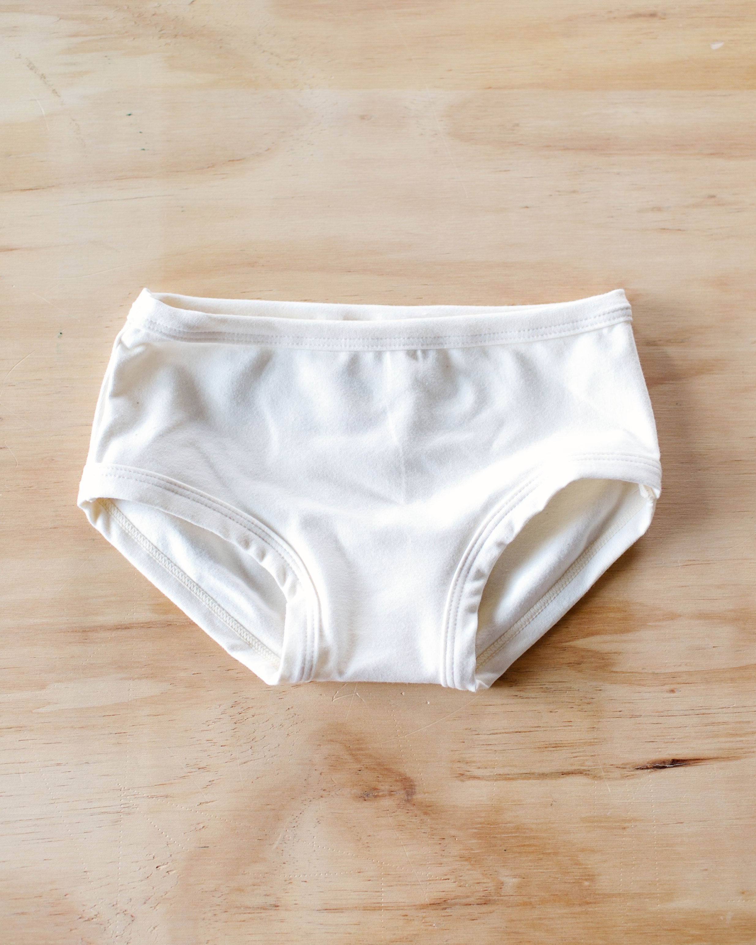 Flat lay of Thunderpants Kids style underwear in plain off-white Vanilla.