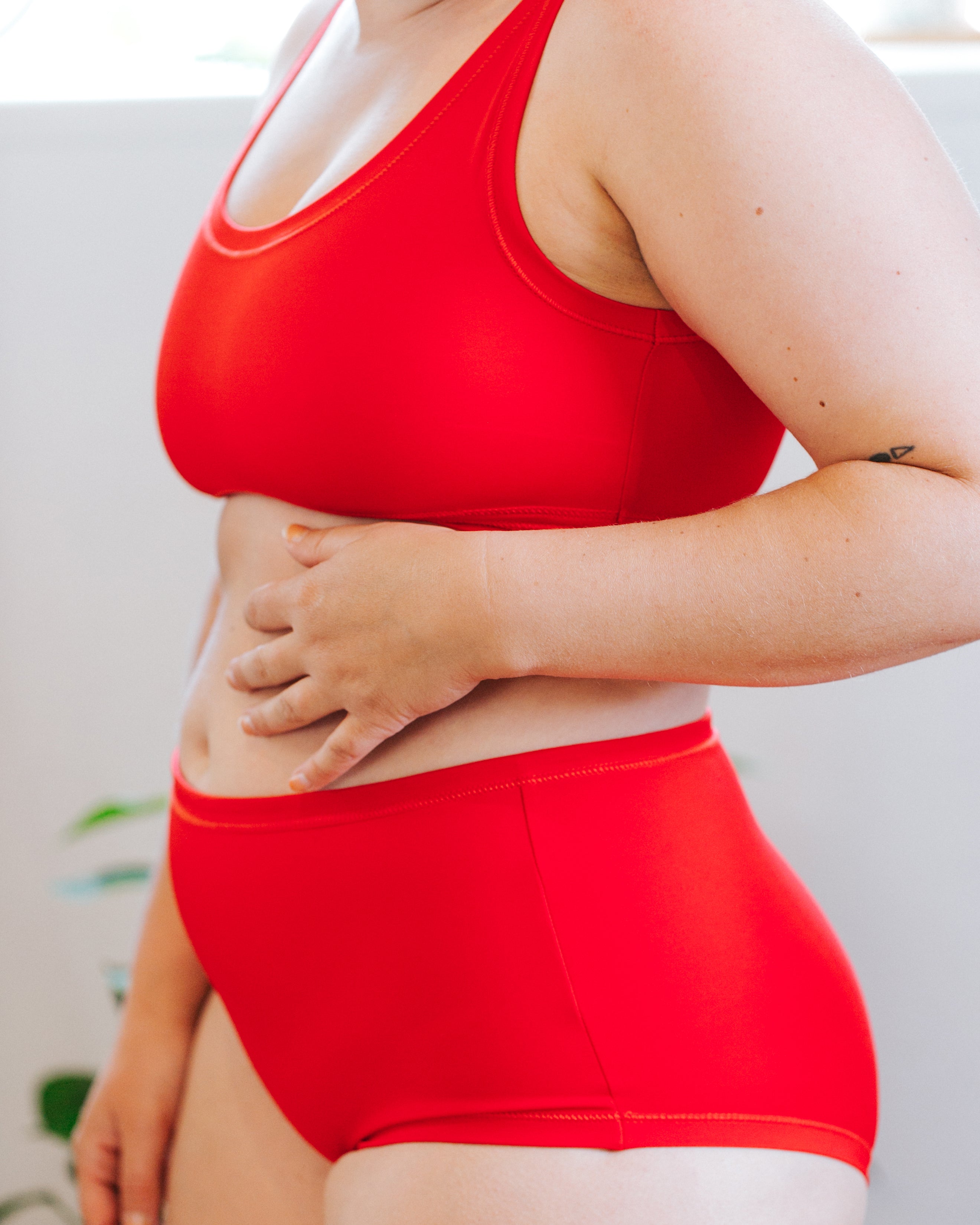 Close up of model wearing Classic Red set with top and Original style bottoms.