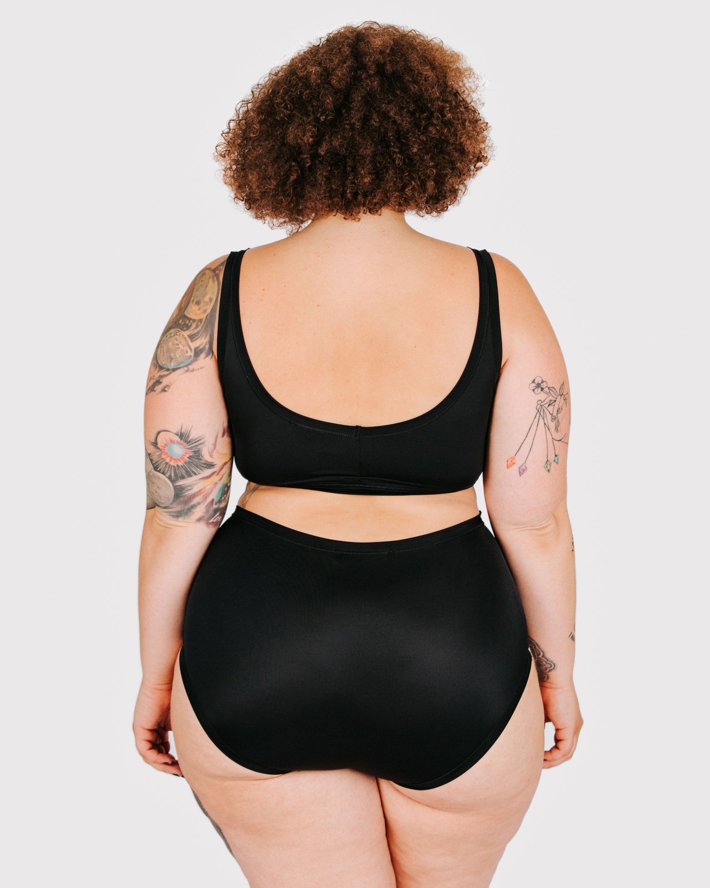 Fit photo from the back of Thunderpants recycled nylon Swimwear Original style bottoms in Plain Black, showing a wedgie-free bum, on a model.