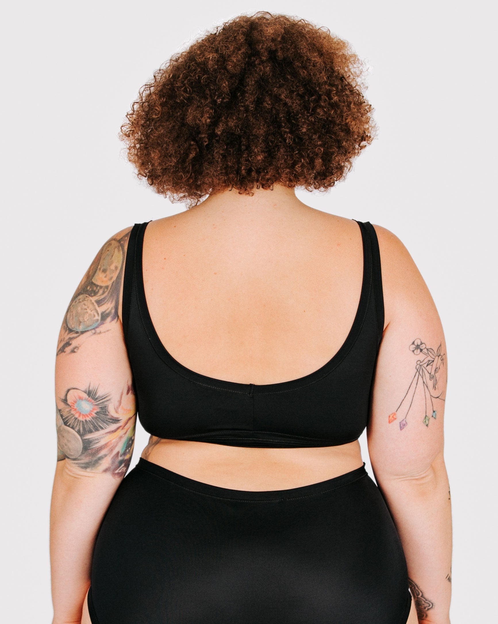 Fit photo from the back of Thunderpants recycled nylon Swimwear Top in Plain Black on a model.