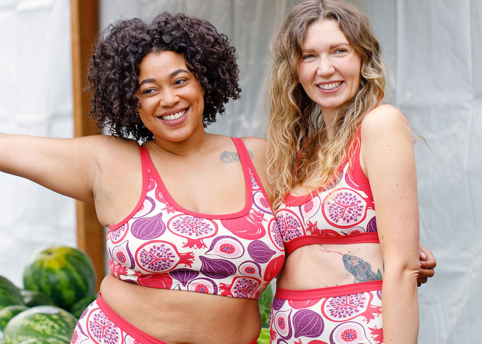 Two models wearing Thunderpants bras in Two Fruits print.