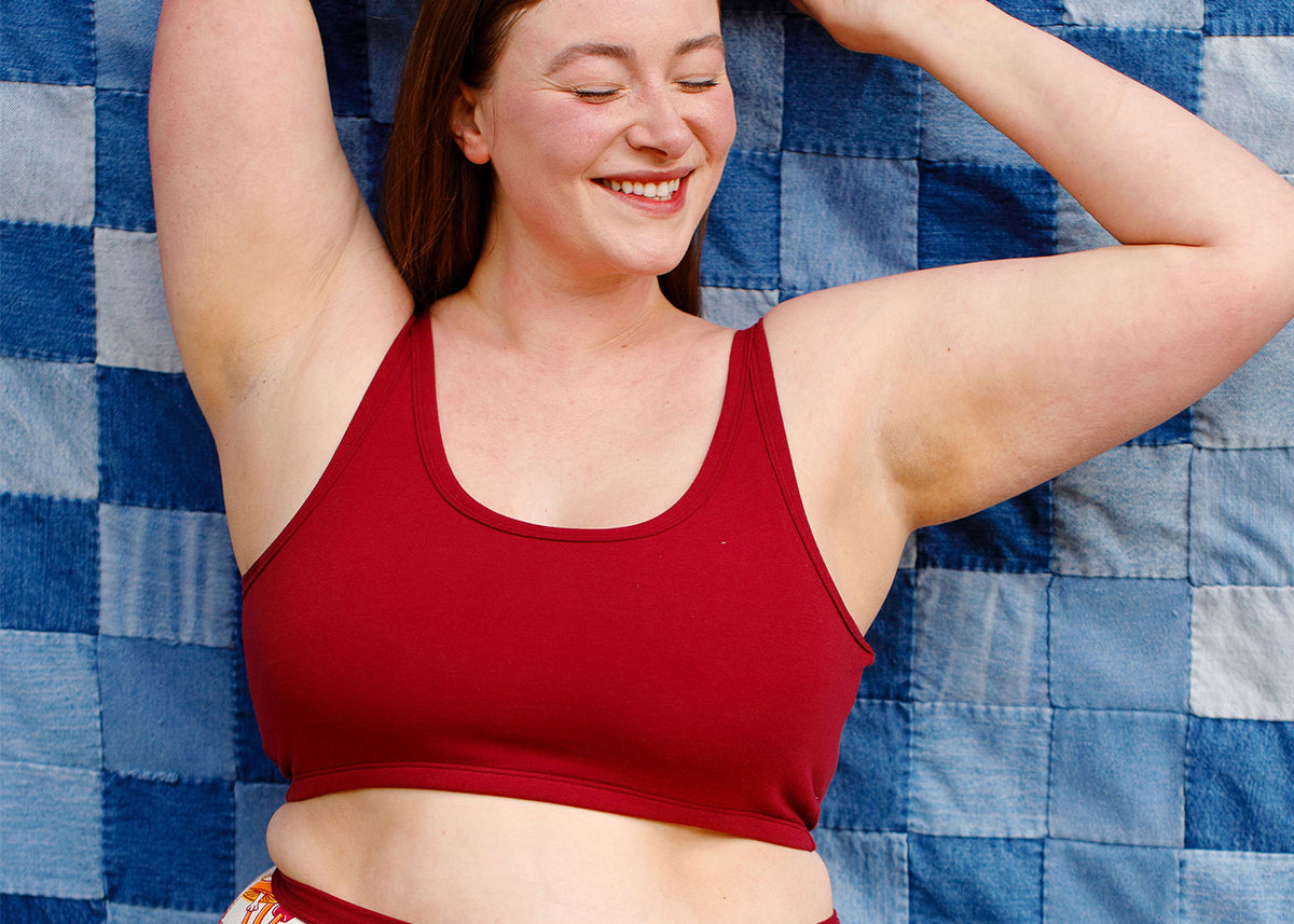 Model wearing a Thunderpants Longline Bra in Cabern-YAY - a dark red wine color.