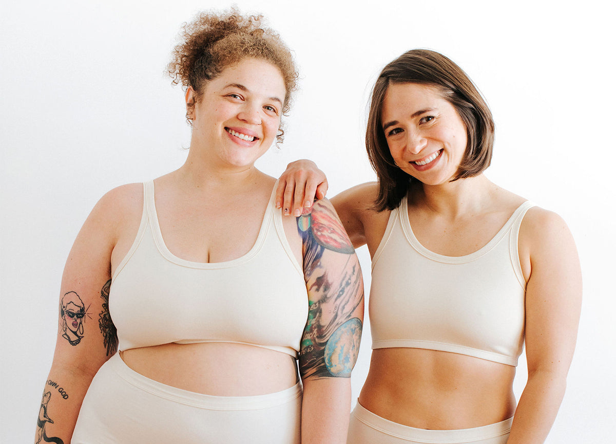 Two models wearing Thunderpants Longline Bra style in Plain Vanilla.