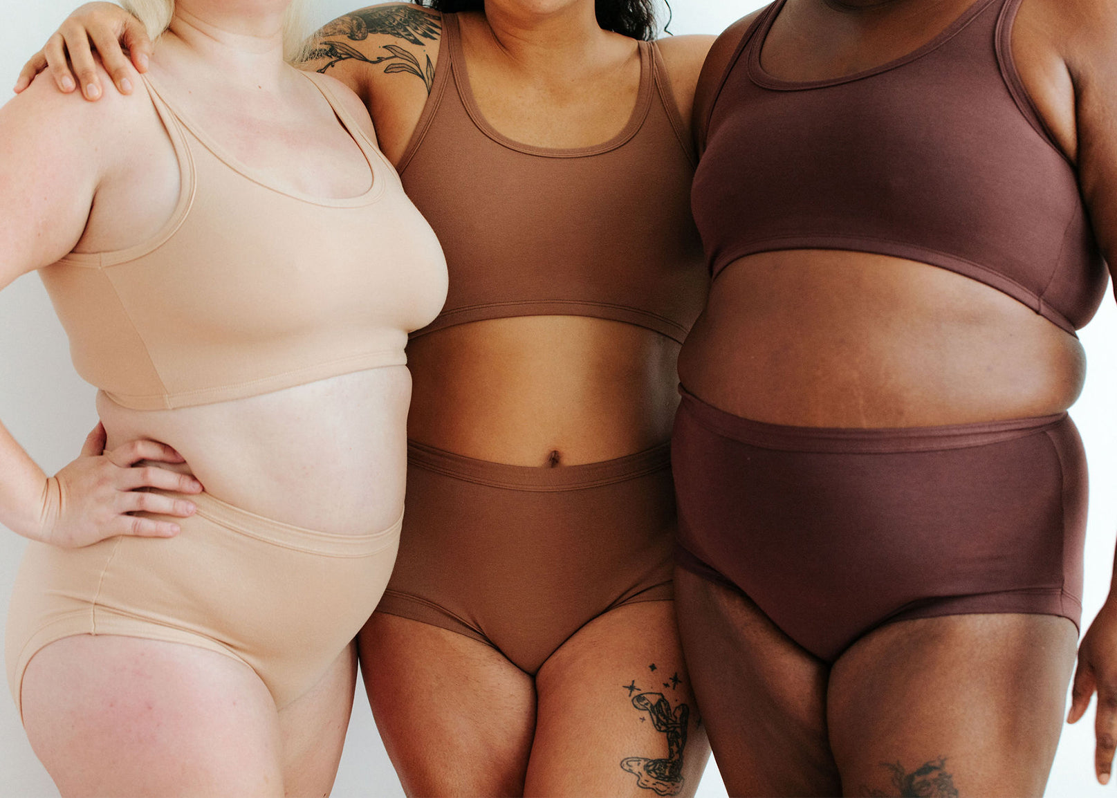 Close up of three models wearing Thunderpants Original style underwear and Longline Bras in our three Neutrals - Pine Nut, Hazelnut, and Chestnut.