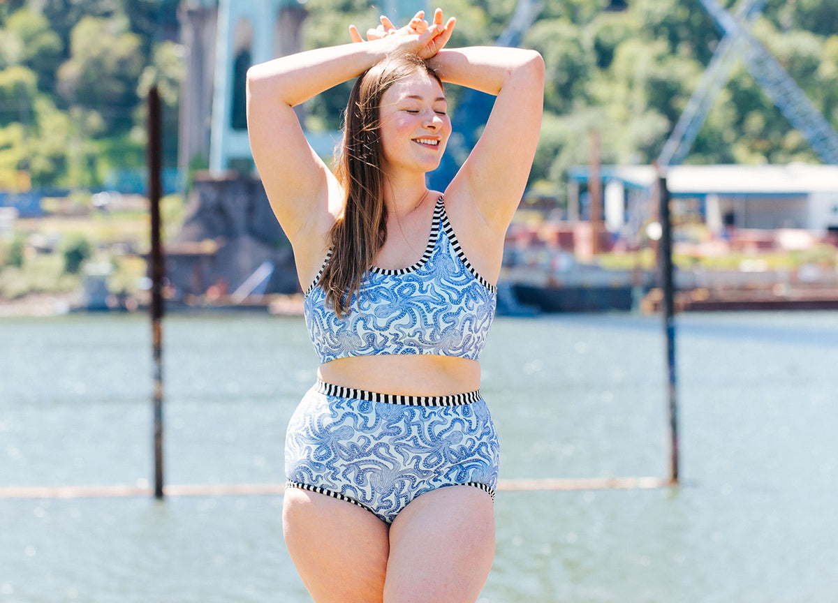 Model smiling outside wearing a set of Thunderpants Longline Bra and Sky Rise style underwear in Octo-Pants print.