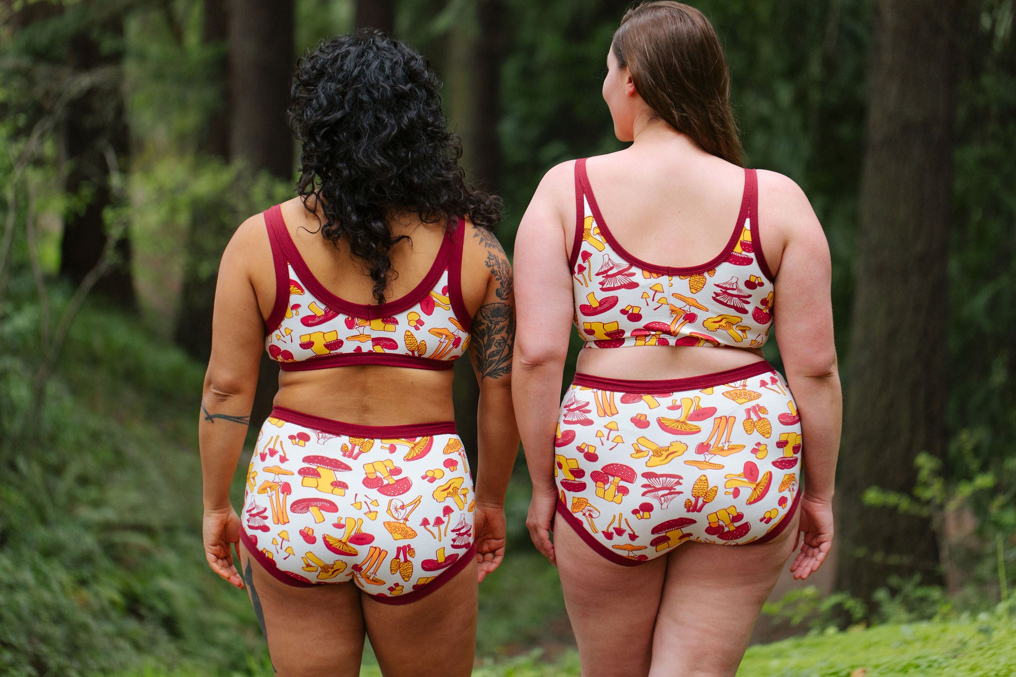 Two models wearing various Thunderpants styles in Whadda Fungi - yellow, orange, and red mushroom print.