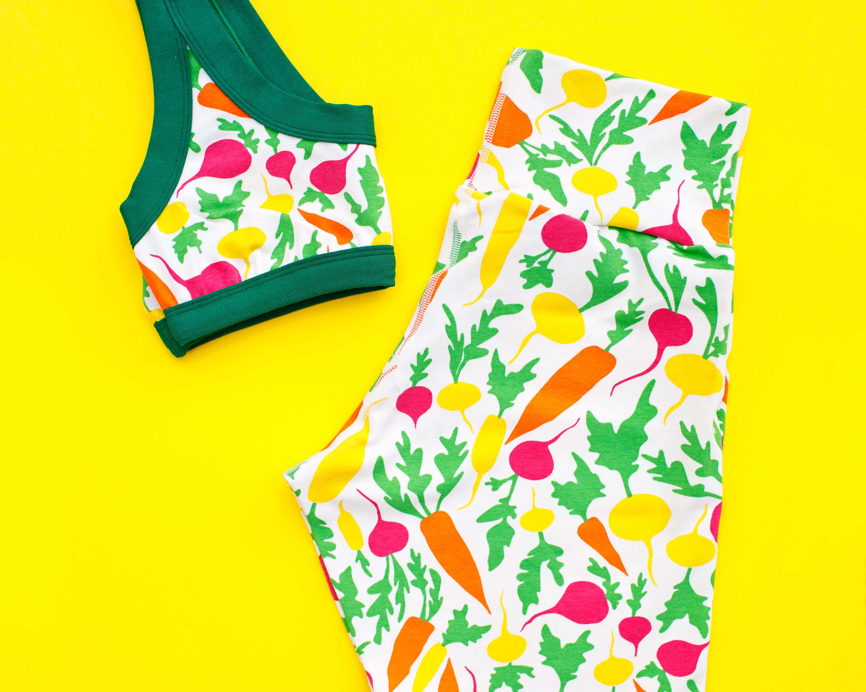 Flat lay of Thunderpants Bike Shorts and Bralette in Root Veggies print.