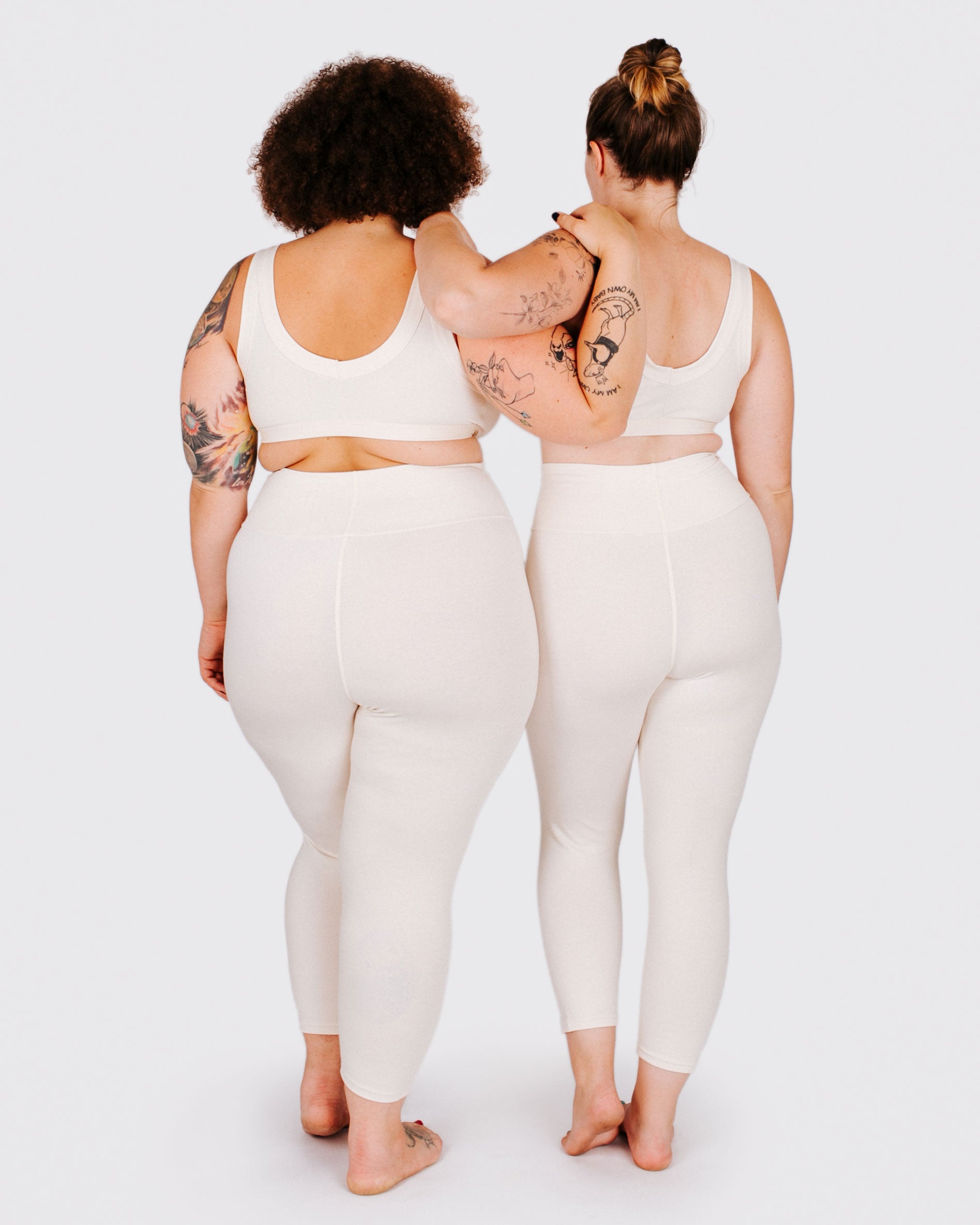Fit photo from the back of Thunderpants organic cotton 3/4 Length Leggings and Bralettes in off-white on two models standing together.