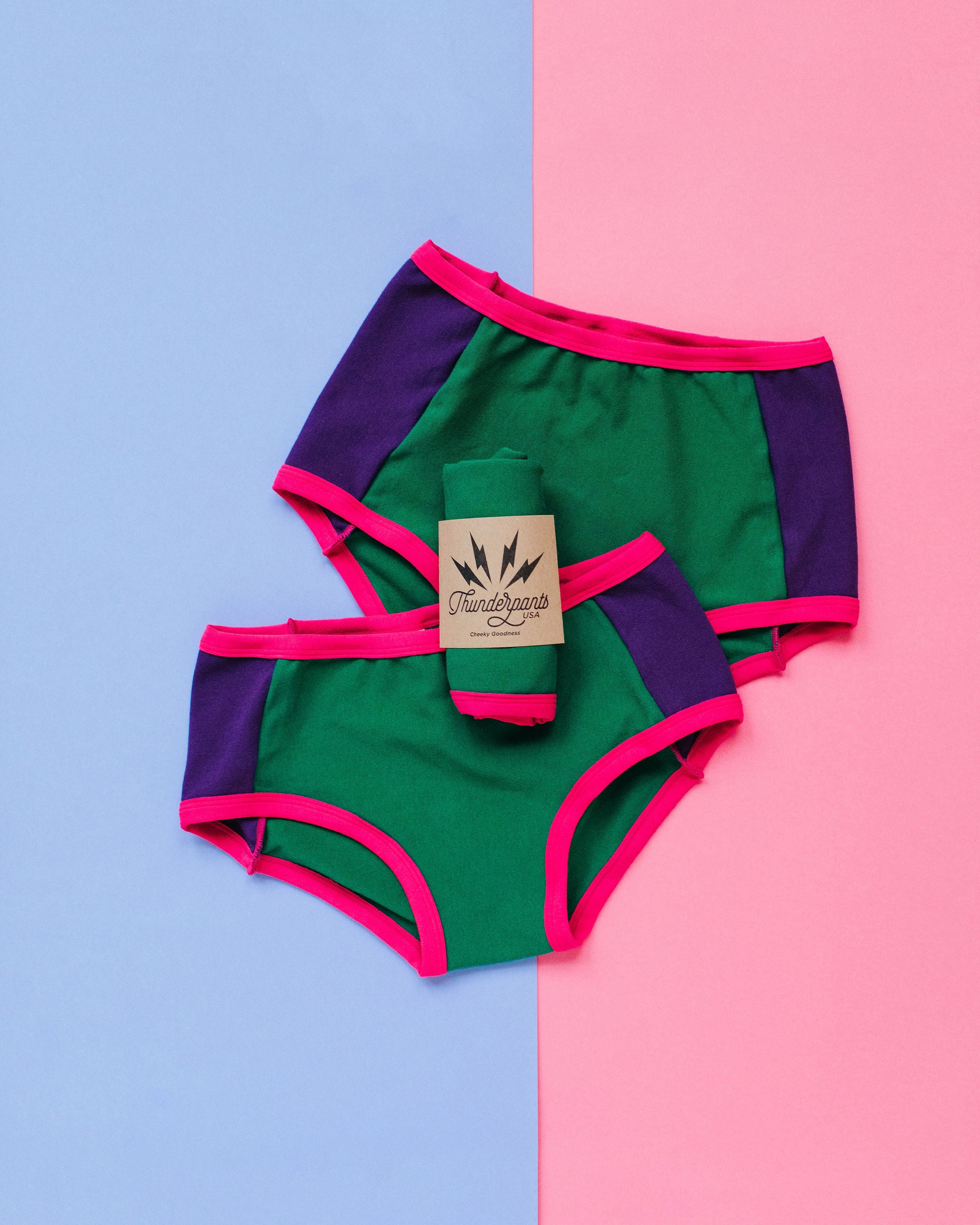 Flat lay of Thunderpants Original and Hipster Panel Pants style underwear in 90's Dream - purple sides, green middle, and pink binding.